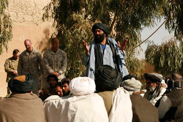 Members of the Government of the Islamic Republic of Afghanistan, alongside Coalition forces representatives take a moment to pray before the security Shura begins in Gereshk, Gereshk district, Helmand province, Nov. 24. The Shura was held in hopes of urging local citizens to take responsibility for the further stabilization of the area.