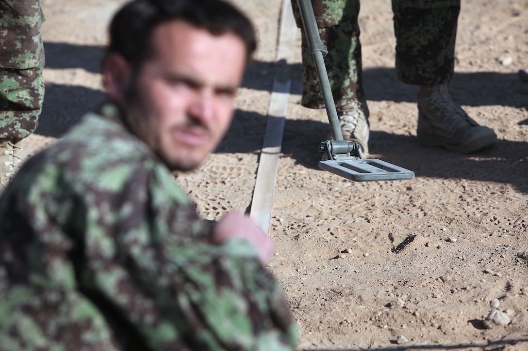 Afghan National Army soldiers practice scanning for improvised explosive devices during an IED course at Camp Dwyer, Helmand province, Afghanistan, Nov. 25. The Regimental Combat Team 1 Embedded Training Team instructed them in identifying IEDs, mitigating IED threats during patrols and identifying various kinds of unexploded ordnance.