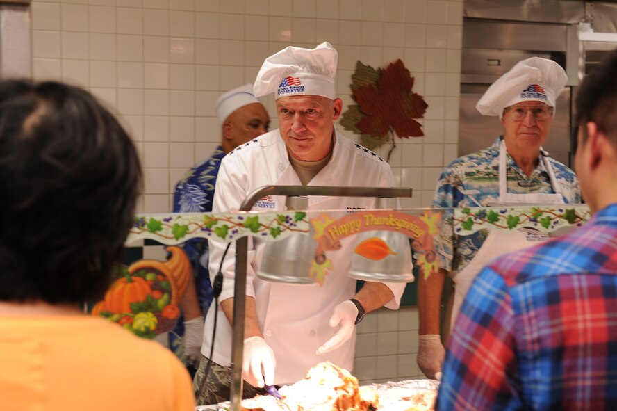 Gen. Gary L. North, the Pacific Air Forces commander and Joseph Goldcamp, an Air Force Civilian Advisory Council member, serve Thanksgiving turkey Nov. 25, 2010, at Joint Base Pearl Harbor-Hickam, Hawaii. Senior leadership from PACAF joined leaders from 13th Air Force and the 15th Wing to serve meals to Airmen, dependents, family members and retirees. (U.S. Air Force photo/Tech. Sgt. Matthew McGovern)