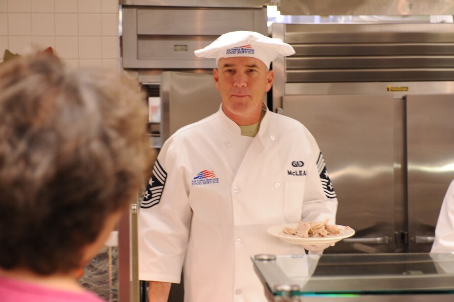 Chief Master Sgt. Brooke McLean, Pacific Air Forces command chief, serves turkey on Thanksgiving Nov. 25, 2010, at the Hale Aina Dining Facility at Joint Base Pearl Harbor-Hickam, Hawaii. Senior leadership from PACAF joined leaders from 13th Air Force and the 15th Wing to serve dinner to Airmen, dependents, family members and retirees. Several members of the Air Force Civilian Advisory Council also volunteered for the event. (U.S. Air Force photo/Tech. Sgt. Matthew McGovern)