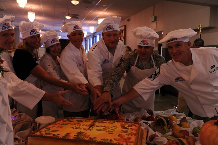Joint Base Pearl Harbor-Hickam leadership cut a Thanksgiving cake after serving meals at the Hale Aina Dining facility Nov. 25, 2010, at JB Hickam, Hawaii. Senior leadership from PACAF joined leaders from 13th Air Force and the 15th Wing to serve dinner to Airmen, dependents, family members and retirees. (U.S. Air Force photo/Tech. Sgt. Matthew McGovern)