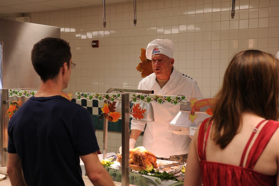 Gen. Gary L. North, the Pacific Air Forces commander, serves turkey on Thanksgiving Nov. 25, 2010, at Joint Base Pearl Harbor-Hickam, Hawaii. Senior leadership from PACAF joined leaders from 13th Air Force and the 15th Wing to serve meals to Airmen, dependents, family members and retirees. (U.S. Air Force photo/Tech. Sgt. Matthew McGovern)