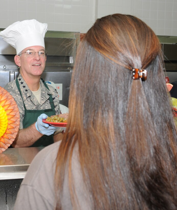 SOTO CANO AIR BASE, Honduras --  Gen. Douglas Fraser, the commander of the U.S. Southern Command, serves Thanksgiving fair while visiting the base Nov. 25. Base leaders and even U.S. Ambassador to Honduras Hugo Llorens also served food to Team Bravo and family members. (U.S. Air Force photo/Tech. Sgt. Benjamin Rojek)