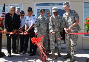 SOTO CANO AIR BASE, Honduras --  (From left) U.S. Ambassador Hugo Lorens, Col. Gregory Reilly, Col. Ruis Landa Dubon, Col. Wilfredo Reyes, Senior Airman Jaime Perez, Col. Martin Clausen, Spc. Jocelyn Minor and Gen. Douglas Fraser all take part in cutting the ceremonial ribbon during the grand opening ceremony of the new dining facility here Nov. 25. (U.S. Air Force photo/Tech. Sgt. Benjamin Rojek)