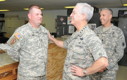 SOTO CANO AIR BASE, Honduras --  Gen. Douglas Fraser, center, the commander of U.S. Southern Command, chats with Sgt. 1st Class Alan King, left, of the 1-228th Aviation Regiment, as Lt. Col. James Kanicki, the 1-228th commander, looks on. General Fraser visited with Team Bravo members to thank them for their service. (U.S. Air Force photo/Tech. Sgt. Benjamin Rojek)