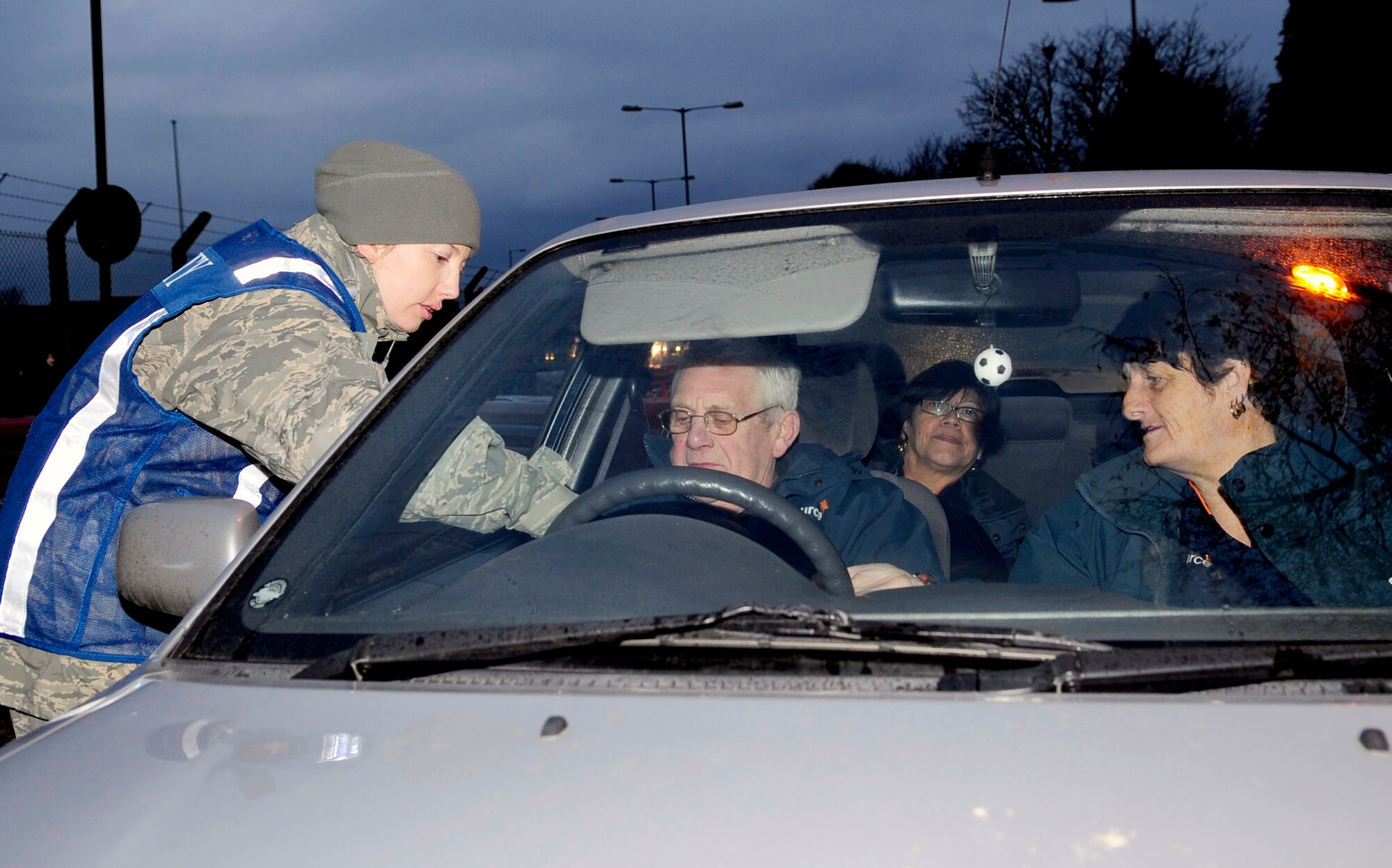 RAF MILDENHALL, England -- Staff Sgt. Natalie Turner, 100th Air Refueling Wing safety noncommissioned officer in charge of ground safety, passes along winter driving to Team Mildenhall members on their way out the back gate Nov. 24, 2010. Commanders, first shirts, and Safety Office personnel manned base departure gates to pass along safety tips to Airmen while they left for the Thanksgiving holiday weekend. (U.S. Air Force photo/Senior Airman Ethan Morgan)