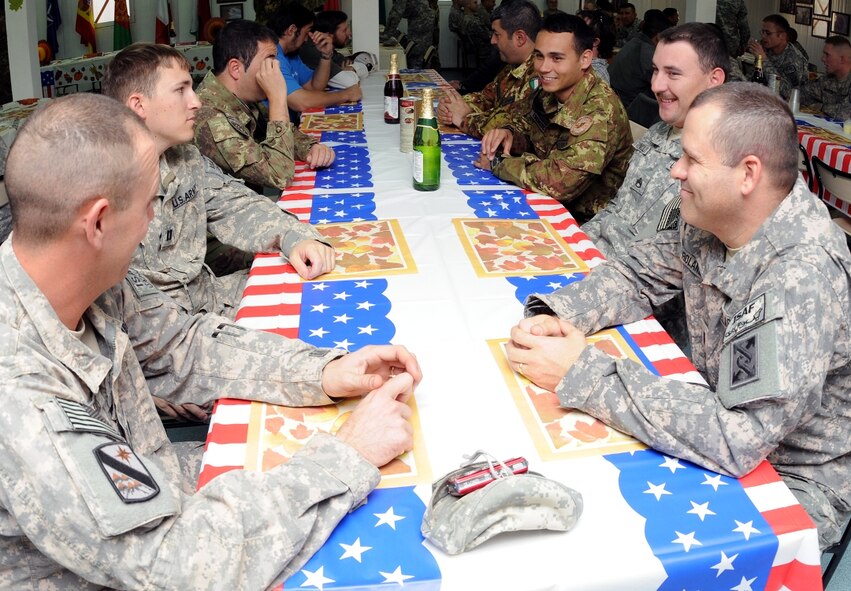Italian, Spanish and U.S. servicemembers at Camp Arena, Herat province, Afghanistan, converse prior to a Thanksgiving dinner Nov. 25. For the American servicemembers living among 1,600 Italian soldiers and airmen, and a few hundred Spanish soldiers, Thanksgiving dinner was more-or-less a mission in the making, but proved to be successful in the end. (U.S. Air Force photo/Tech. Sgt. Kevin Wallace)