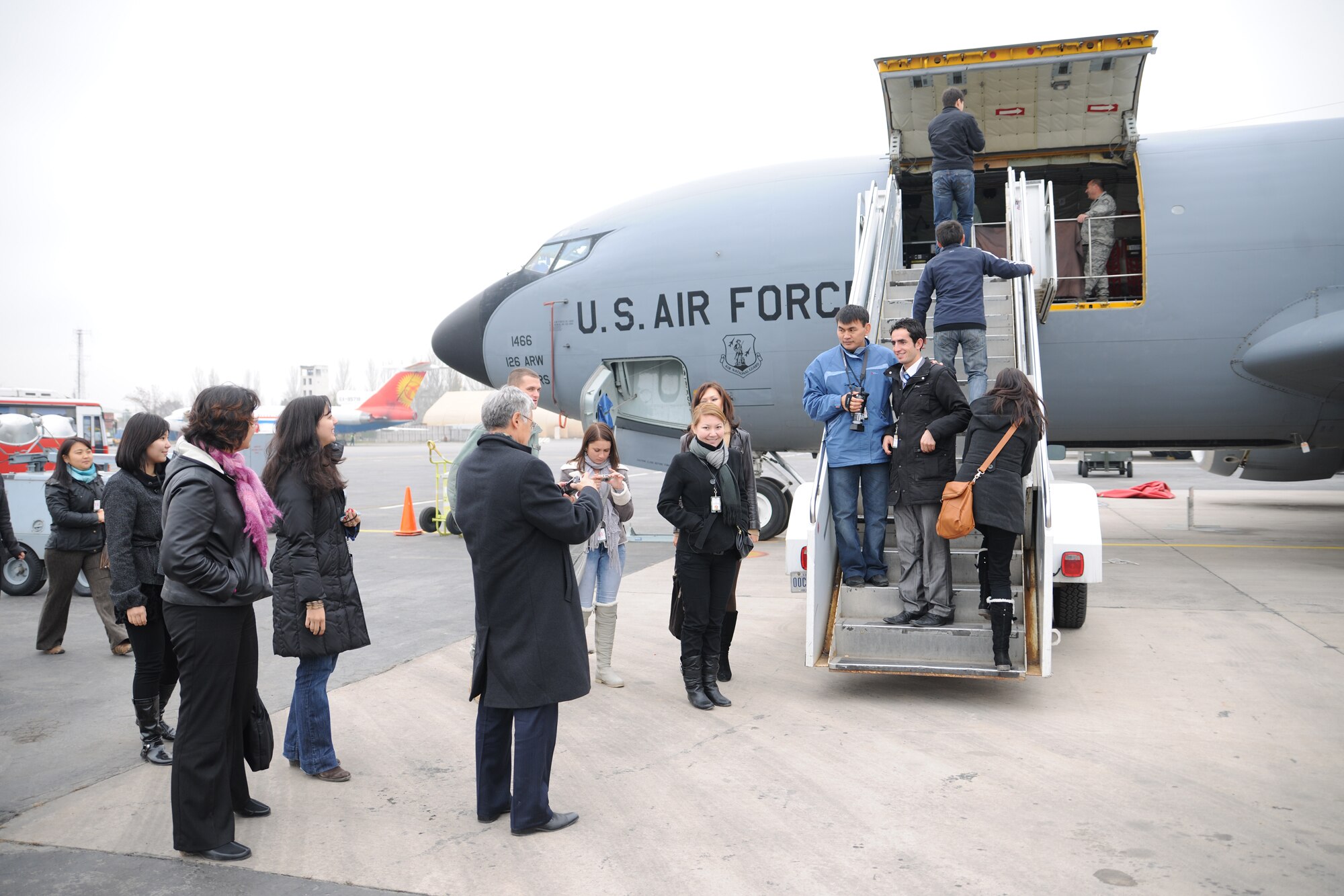 TRANSIT CENTER AT MANAS, Kyrgyzstan - University students receive a tour of a KC-135 Stratotanker on the Transit Center at Manas Nov. 25.  Four local universities participated in a tour and ate a traditional holiday lunch with the troops in celebration of Thanksgiving Day.  (U.S. Air Force photo/Staff Sgt. Nathan Bevier)