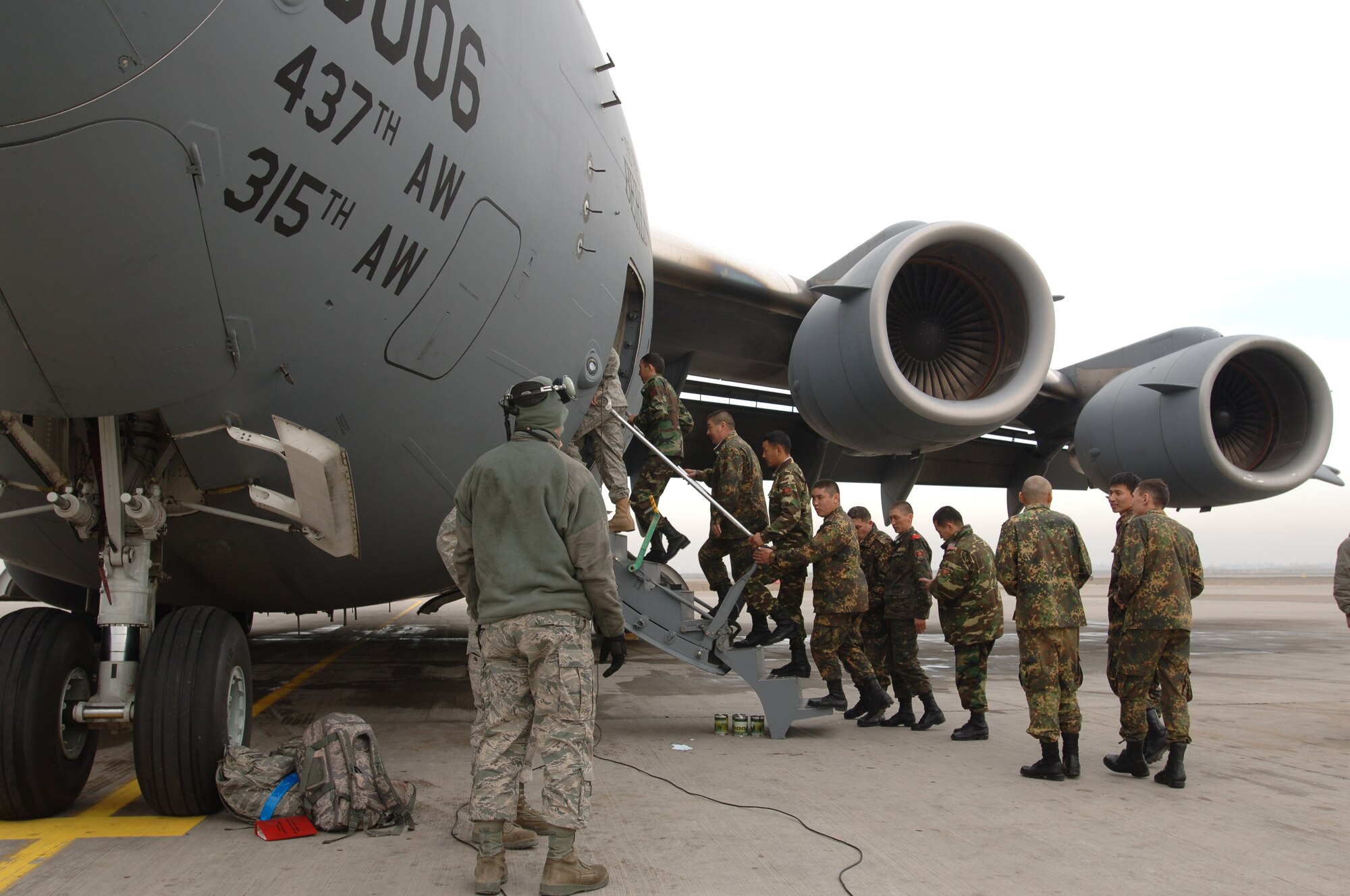 TRANSIT CENTER AT MANAS, Kyrgyzstan - Koi-Tosh Non-Commissioned Officers' Academy receive a tour of a C-17 Globemaster III at the Transit Center at Manas Nov. 25.  They received a tour of the Center and ate lunch with the troops in celebration of Thanksgiving Day. (U.S. Air Force photo/Master Sgt. Paul Cox)