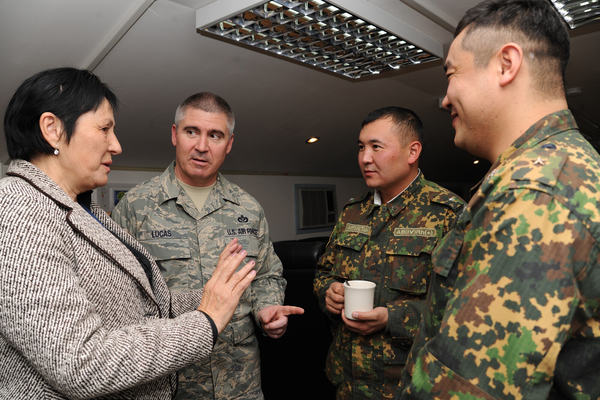 TRANSIT CENTER AT MANAS, Kyrgyzstan - Chief Master Sgt. James Lucas, 376th Air Expeditionary Wing command chief, and Mrs. Valentina Turabekova, cultural advisor to the commander, speak with members of the Koi-Tosh Non-Commissioned Officers' Academy visit the Transit Center at Manas before a mission briefing Nov. 25.  They received a tour of the Center and ate lunch with the troops in celebration of Thanksgiving Day. (U.S. Air Force photo/Staff Sgt. Nathan Bevier)