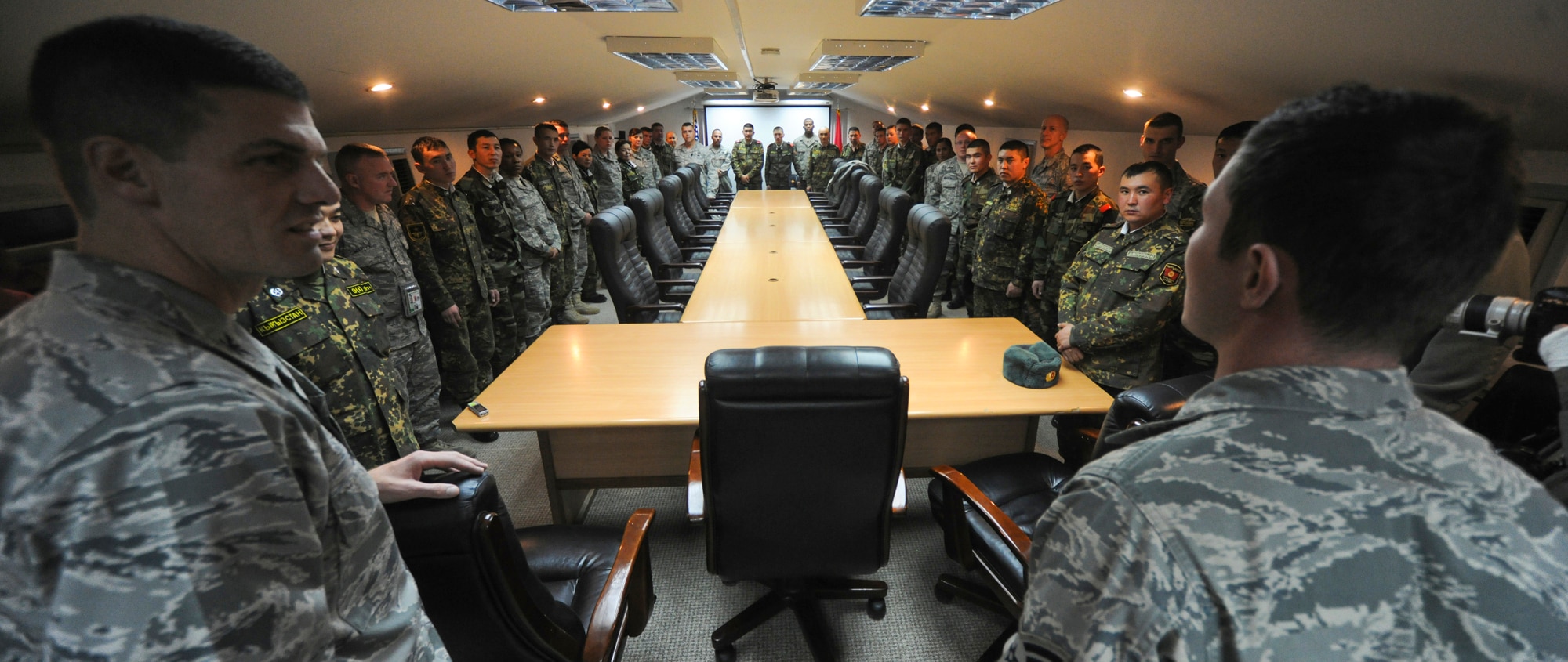 TRANSIT CENTER AT MANAS, Kyrgyzstan - Col. Dwight Sones, 376th Air Expeditionary Wing commander, and Senior Airman Ilya Volovik, 376th Air Expeditionary Wing coalition coordinator and linguist, welcomes the Koi-Tosh Non-Commissioned Officers' Academy to the Transit Center at Manas for celebration of Thanksgiving Day Nov. 25.  (U.S. Air Force photo/Staff Sgt. Nathan Bevier)