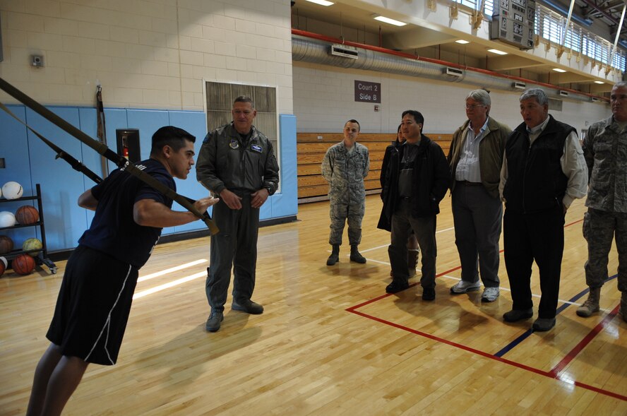 Gen. Gary North, Pacific Air Forces commander, center, and Hawaii-based civic leaders observe a TRX Suspension Training system demonstration Nov. 24 in the fitness center at Osan Air Base, Republic of Korea. (U.S. Air Force photo/Senior Airman Evelyn Chavez)