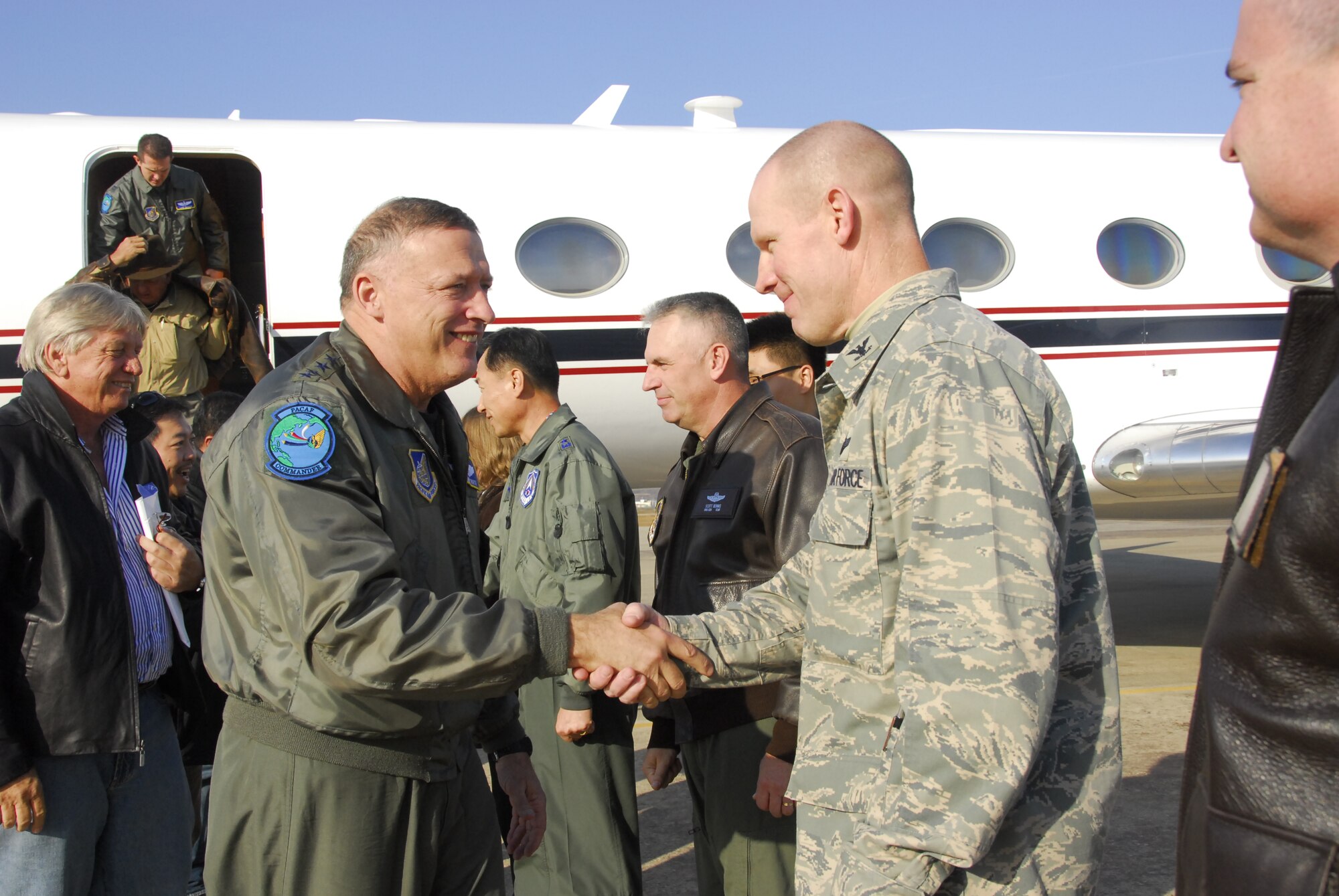 Gen. Gary North, Pacific Air Forces commander, left, shakes hands with Col. Patrick Malackowski, 51st Fighter Wing commander, following the general's arrival Nov. 23 at Osan Air Base, Republic of Korea. (U.S. Air Force photo/Staff Sgt. Eunique Stevens)