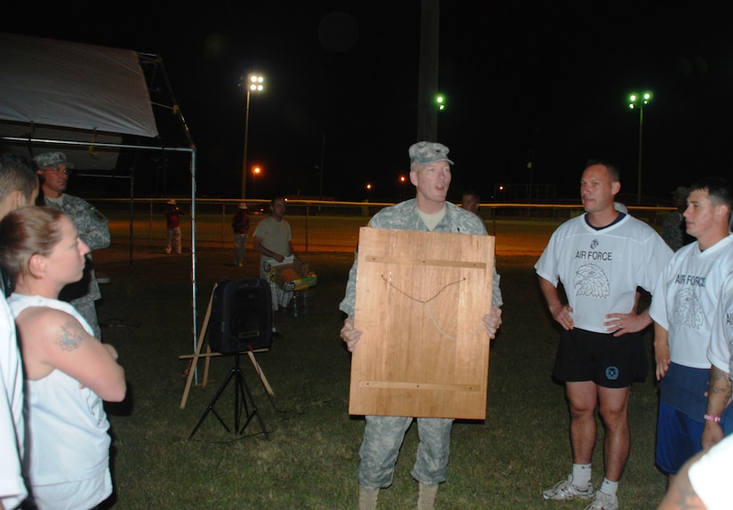 SOTO CANO AIR BASE, Honduras - Joint Task Force-Bravo commander Col. Greg Reilly (center) presents the winner's plaque to the base Air Force flag football team at the conclusion of the sixth annual "Turkey Bowl" here Nov. 24.  The base Air Force team claimed their fourth title in six years, besting the base Army team 30-12. (Air Force photo, Capt. John T. Stamm)