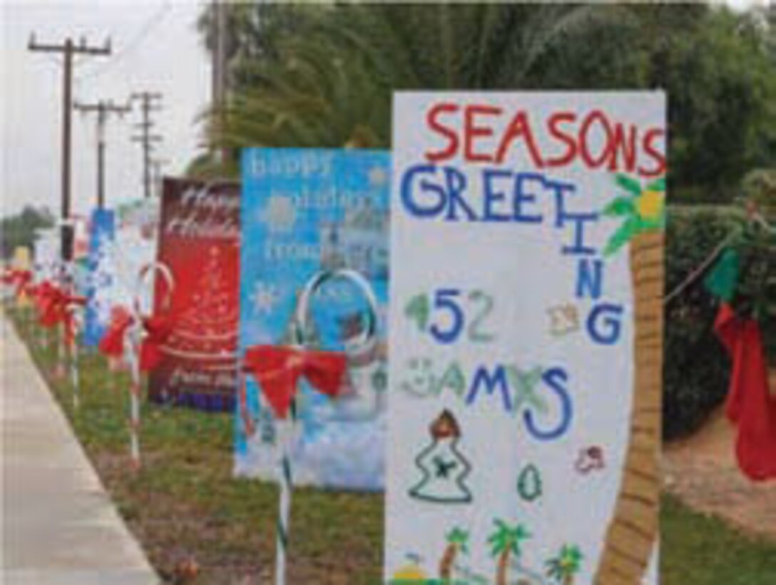 For the past four years, units on base have been sending holiday cheer to those entering the main gate by decorating large poster boards with holiday themed drawings and paintings.  (U.S. Air Force photo)

