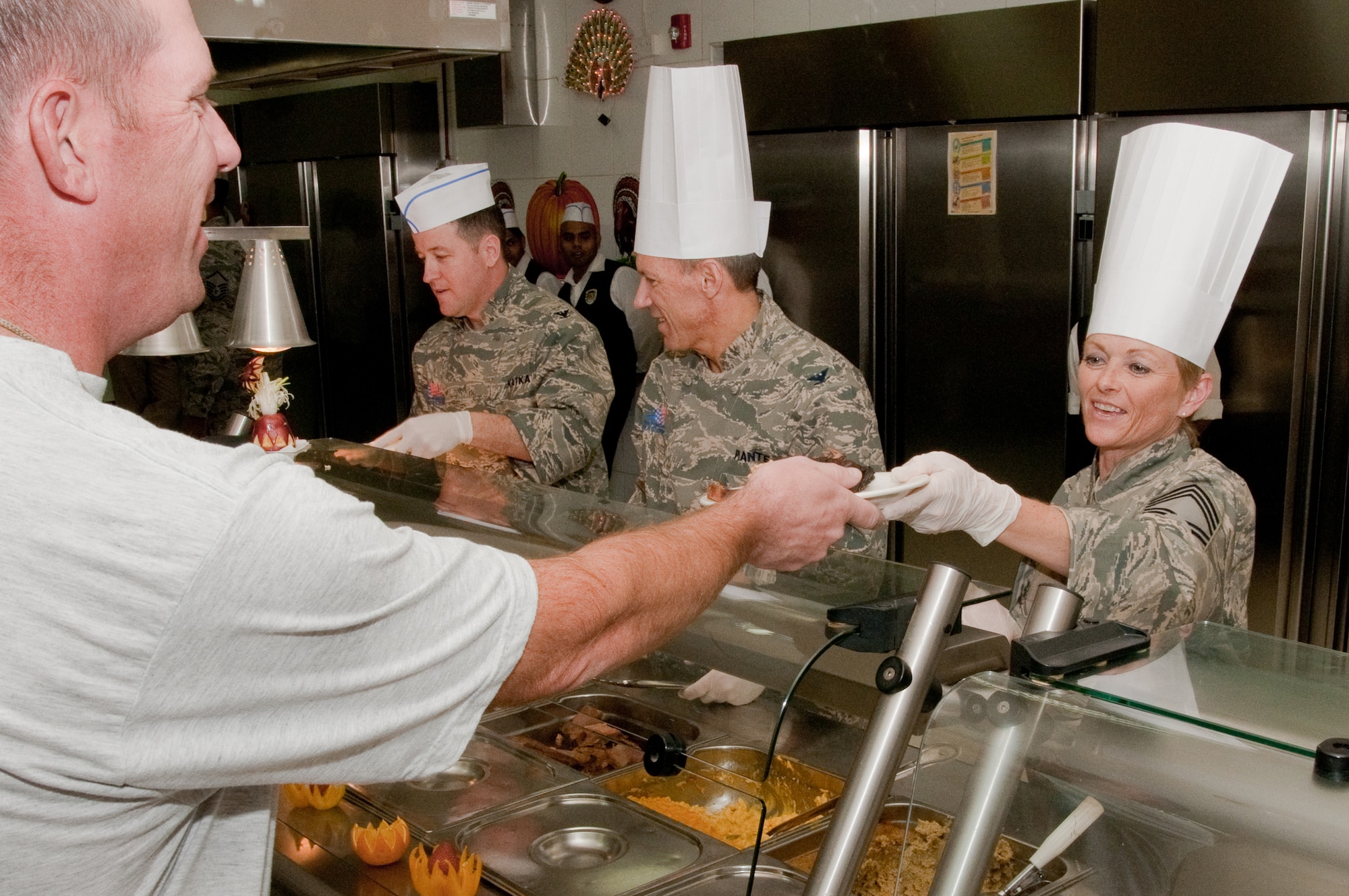SOUTHWEST ASIA -- Chief Master Sgt. Yvonne Miller of the 386th Expeditionary Medical Group serves turkey and roast beef for Thanksgiving Day dinner at an undisclosed air base here Nov. 25, 2010. The base is home to more than 2,000 Airmen assigned to the 386th Air Expeditionary Wing, which serves as the primary airlift hub for coalition forces in Iraq. The wing also provides theater airlift services across Southwest Asia. (U.S. Air Force photo by Maj. Dale Greer/Released)