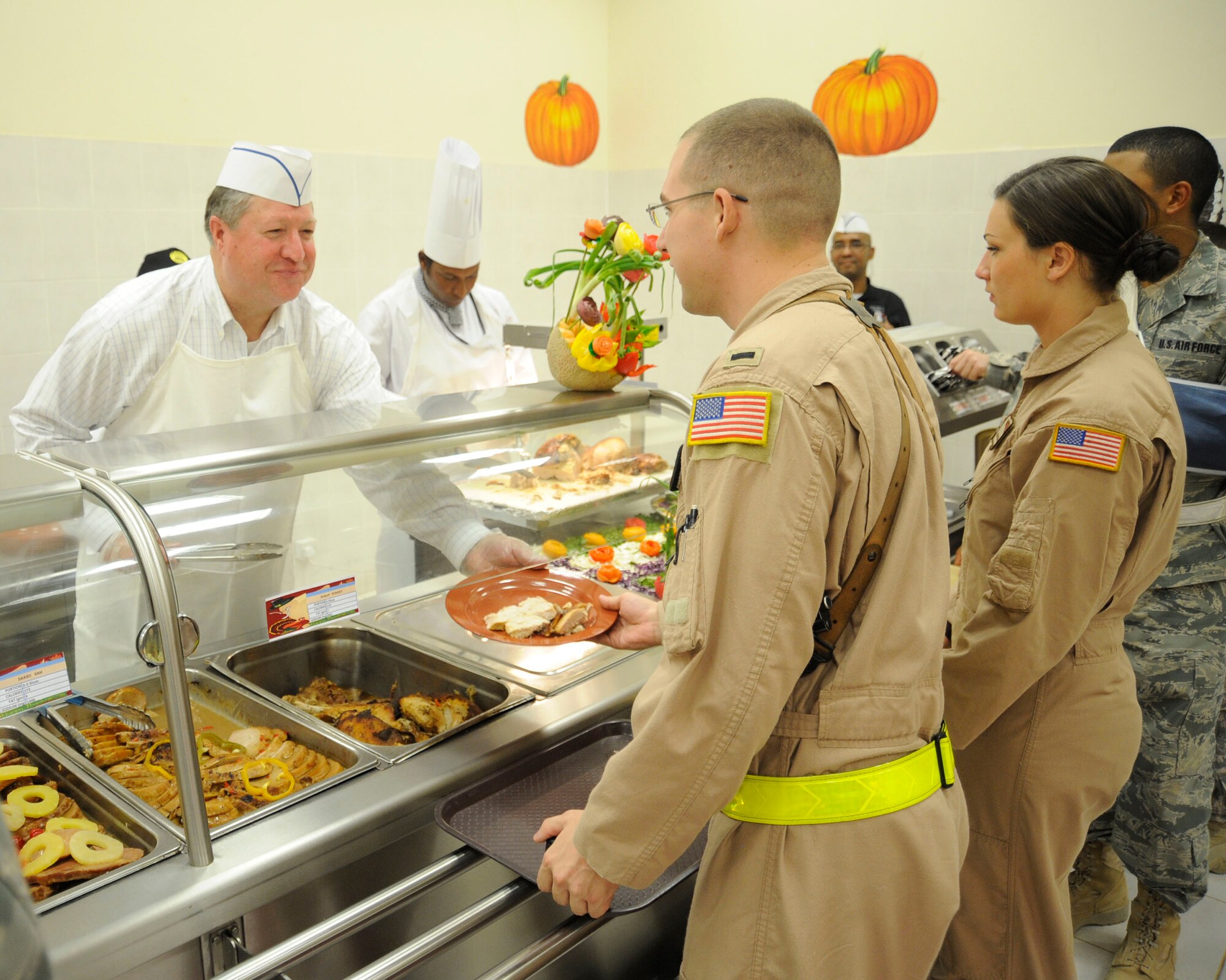 Secretary of the Air Force Michael Donley serves Thanksgiving dinner to Airmen at Joint Base Balad, Iraq, Nov. 25, 2010, during a visit of the base. Secretary Donley toured several squadrons and also addressed members of the 332nd Air Expeditionary Wing during an Airman’s Call.  Lt. Gen. Mike Hostage, the commander of Air Forces Central Command, and Chief Master Sgt. of the Air Force James A. Roy also were present. (U.S. Air Force photo/ Senior Airman Matt Coleman-Foster)