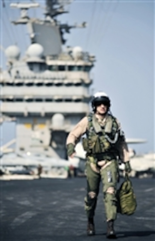 U.S. Marine Corps Capt. William Paxton, a pilot assigned to Marine Fighter Attack Squadron 312, walks to his aircraft prior to morning flight operations aboard the aircraft carrier USS Harry S. Truman (CVN 75) in the Arabian Sea on Nov. 9, 2010.  Marine Fighter Attack Squadron 312 was part of the Harry S. Truman Carrier Strike Group which supported maritime security operations and theater security cooperation efforts.  