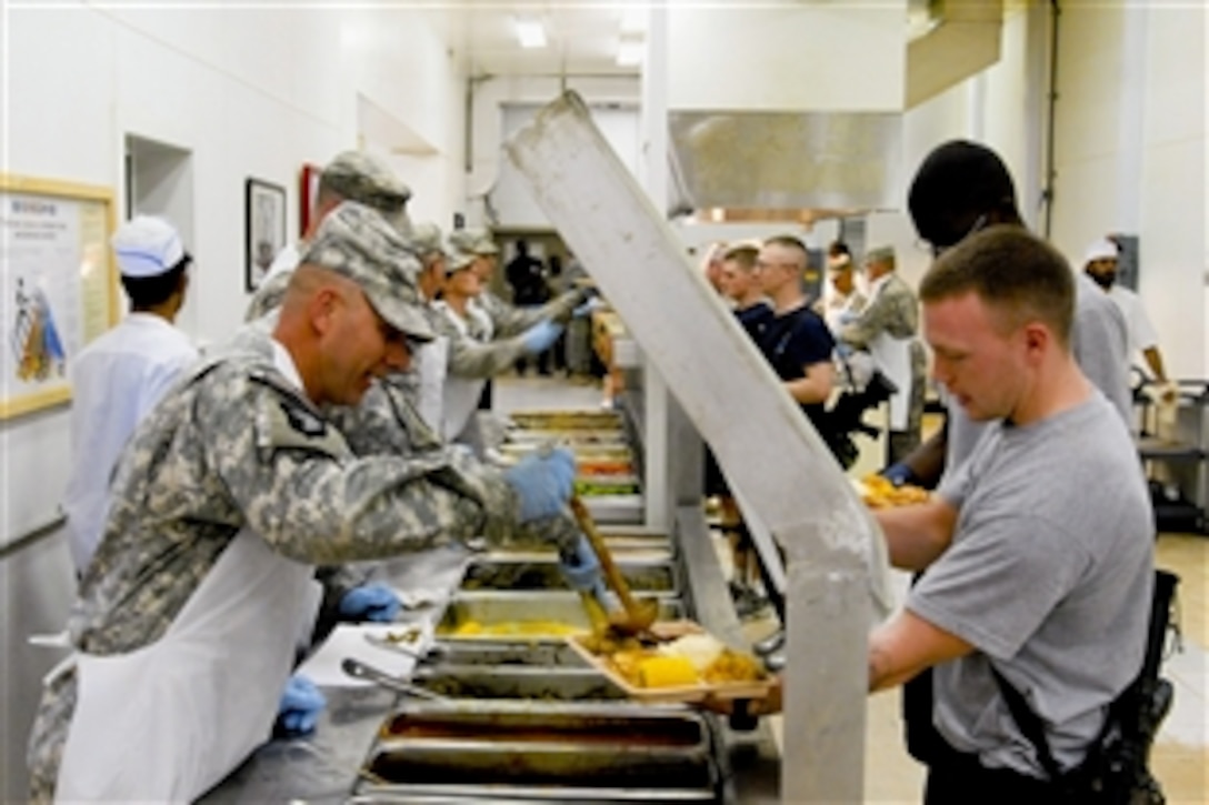 U.S. Army Command Sgt. Maj. Dan Kerrigan and other senior-enlisted members from the 3-19th Indiana Agribusiness Development Team serve Thanksgiving dinner to the troops of Forward Operating Base Salerno, Khowst Province, Afghanistan Nov. 25, 2010.
