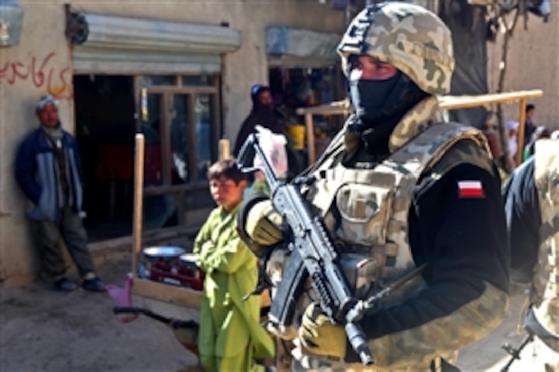 A Polish soldier serving with the NATO International Security Assistance Force pulls security detail in Ghazni, Afghanistan, Nov. 20, 2010