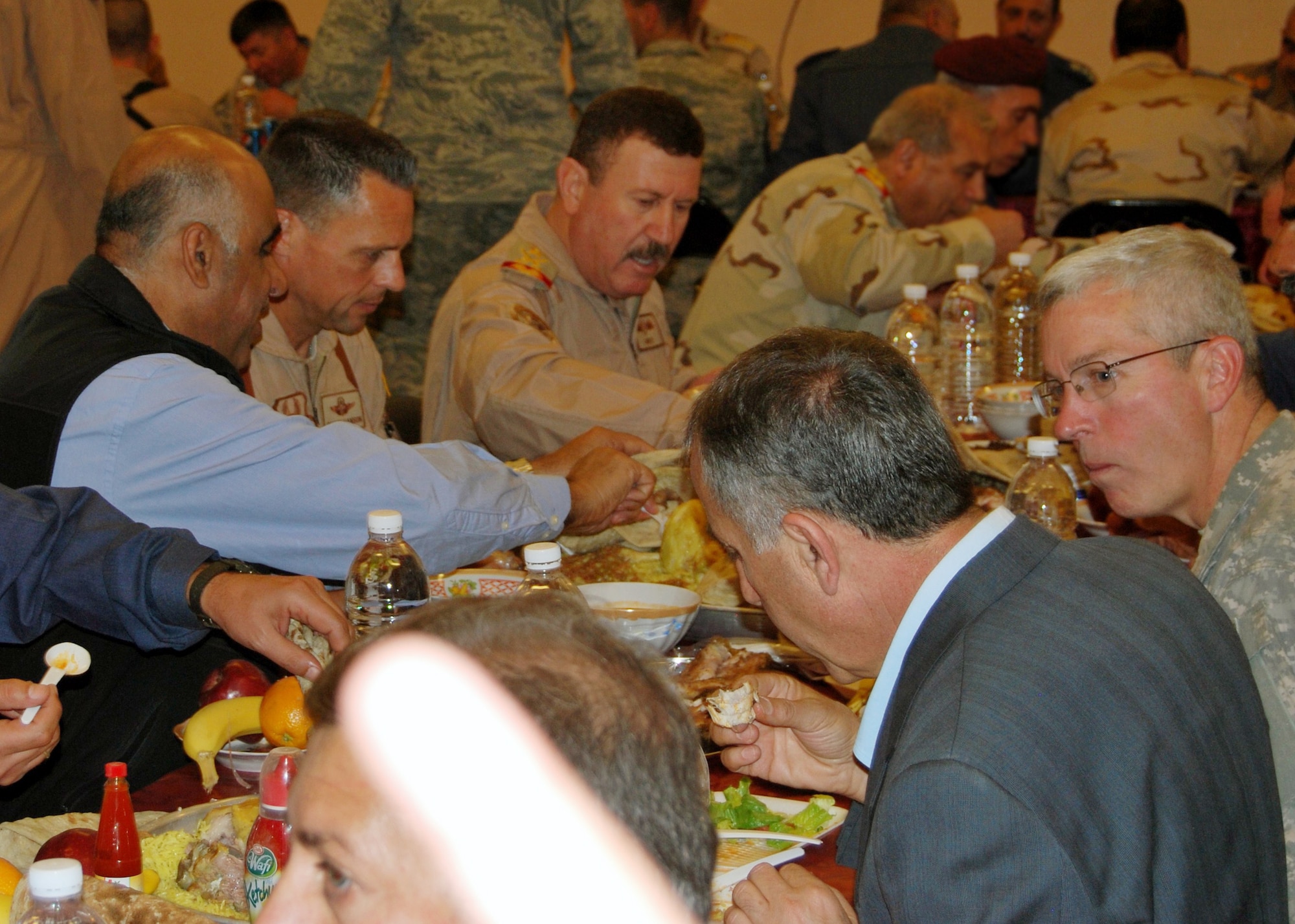 Brig. Gen. Scott Hanson, Commander of the 321st Air Expeditionary Wing and Director of Iraqi Training and Advisory Mission –  Air Force enjoys a traditional Iraqi meal with Staff Lt. Gen. Anwar, Iraqi Air Force Chief of Staff, after a ceremony at Ali Air Base, Iraq, which was designed to celebrate the arrival of the Iraqi Air Force's Squadron 70 and the grand opening of their new dining facility.  Squadron 70 moved to Ali Base Oct. 17 from Basra. Since the move, Squadron 70 has provided surveillance and reconnaissance support of the Hajj, provided ISR support for Iraqi Security Forces and secured Iraqi’s vital infrastructure and borders. (U.S. Air Force photo by Staff Sgt. Eric Donner)