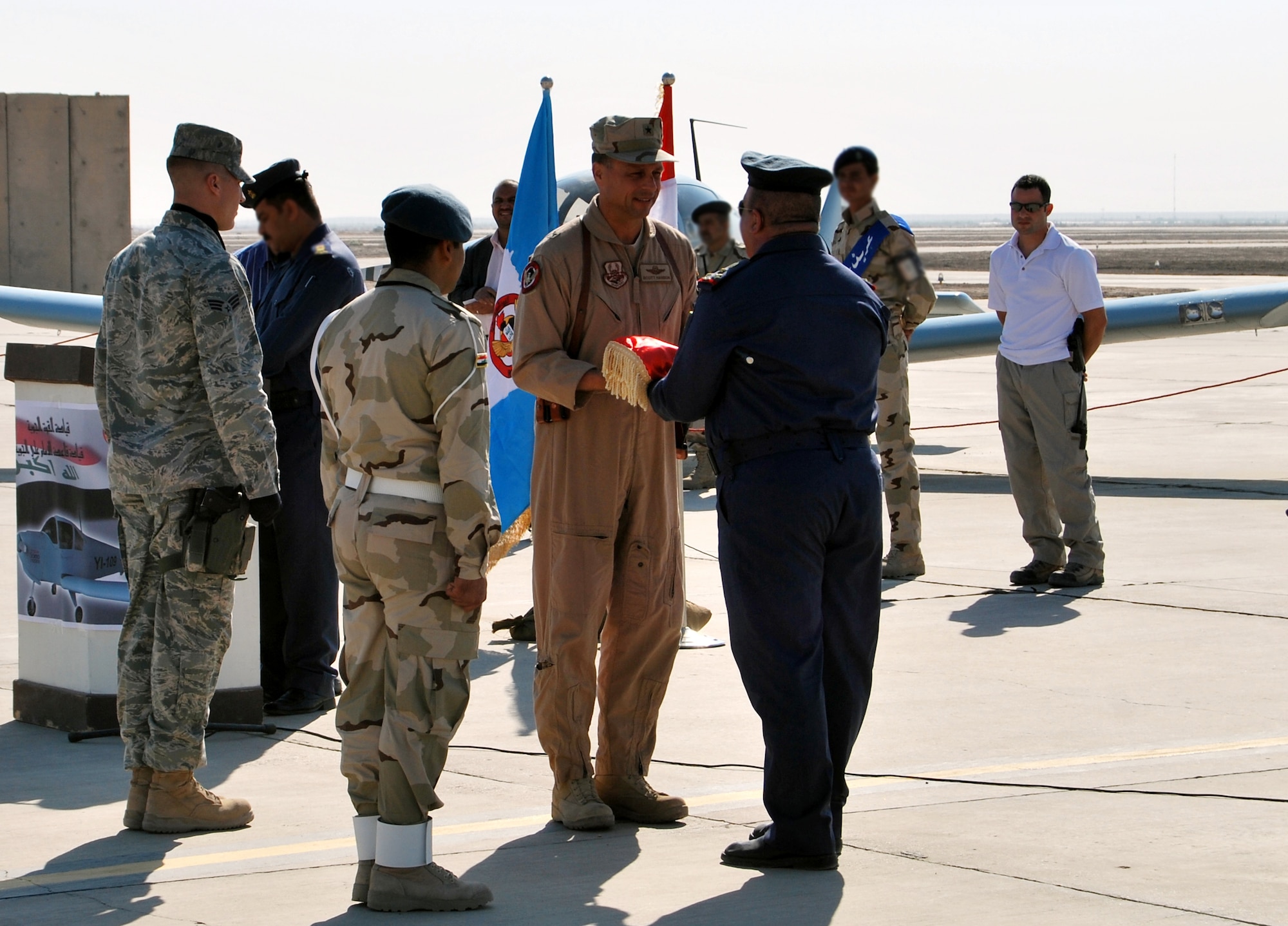 Brig. Gen. Scott Hanson, Commander of the 321st Air Expeditionary Wing and Director of Iraqi Training and Advisory Mission –  Air Force exchanges gifts at Ali Air Base, Iraq, during a ceremony celebrating the arrival of the Iraqi Air Force's Squadron 70 and the grand opening of their new dining facility.  Squadron 70 moved to Ali Base Oct. 17 from Basra. Since the move, Squadron 70 has provided surveillance and reconnaissance support of the Hajj, provided ISR support for Iraqi Security Forces and secured Iraqi’s vital infrastructure and borders.(U.S. Air Force photo by Staff Sgt. Eric Donner)