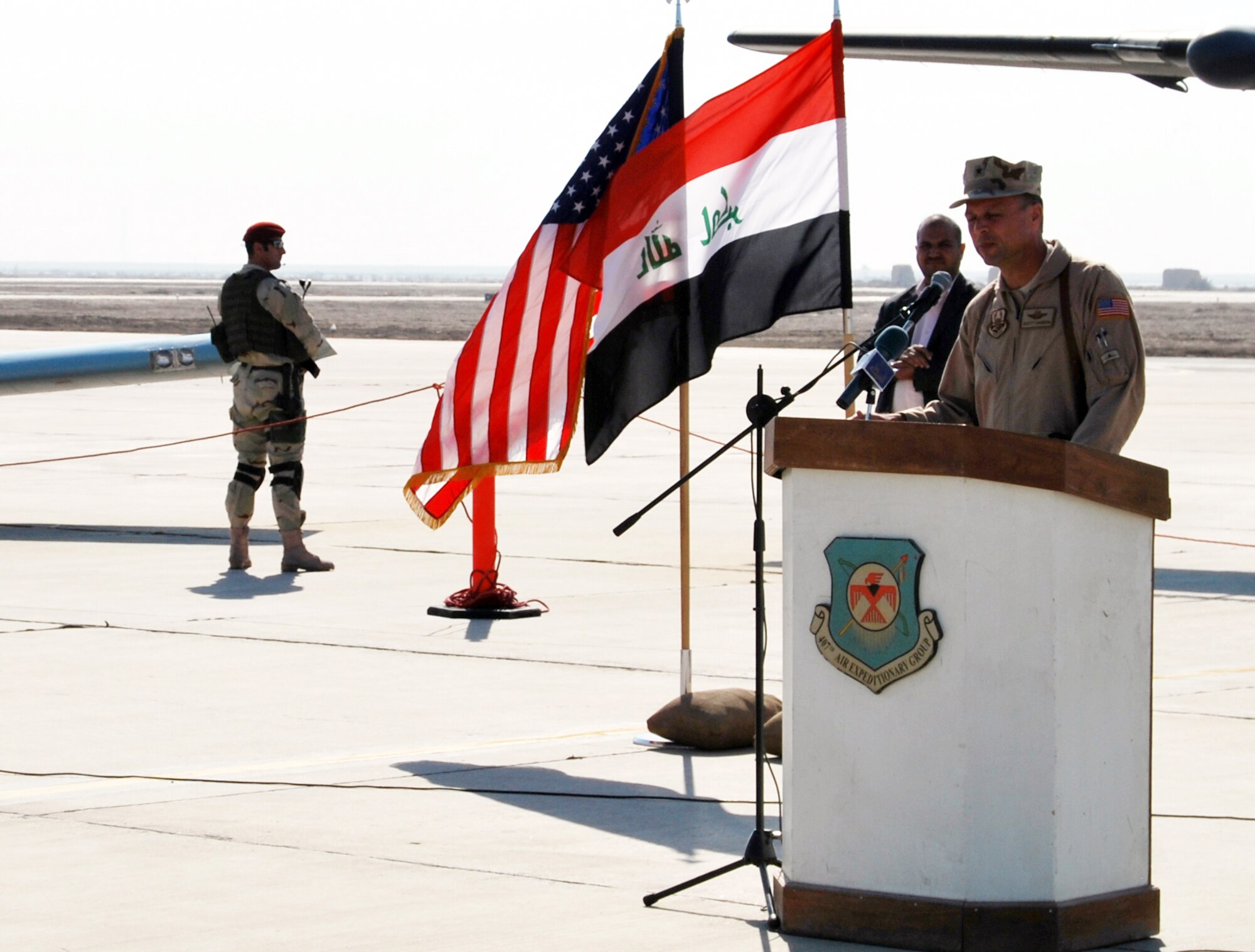 Brig. Gen. Scott Hanson, Commander of the 321st Air Expeditionary Wing and Director of Iraqi Training and Advisory Mission –  Air Force addresses audience members gatherd at Ali Air Base, Iraq, during a ceremony celebrating the arrival of the Iraqi Air Force's Squadron 70 and the grand opening of their new dining facility.  Squadron 70 moved to Ali Base Oct. 17 from Basra. Since the move, Squadron 70 has provided surveillance and reconnaissance support of the Hajj, provided ISR support for Iraqi Security Forces and secured Iraqi’s vital infrastructure and borders.(U.S. Air Force photo by Staff Sgt. Eric Donner)
