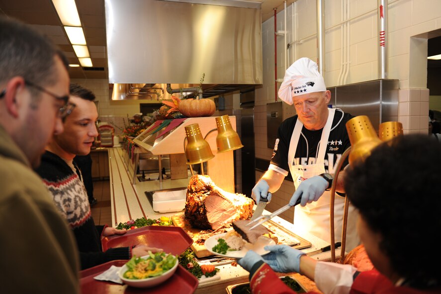 KUNSAN AIR BASE, Republic of Korea -- Gen. Gary North, Pacific Air Forces commander, serves a slice of roast beef to Airmen at the O'Malley Dining Facility on Thanksgiving here Nov. 25.  Gen. North was visiting several bases within the command during the week. (U.S. Air Force photo/Staff Sgt. Jonathan Pomeroy)