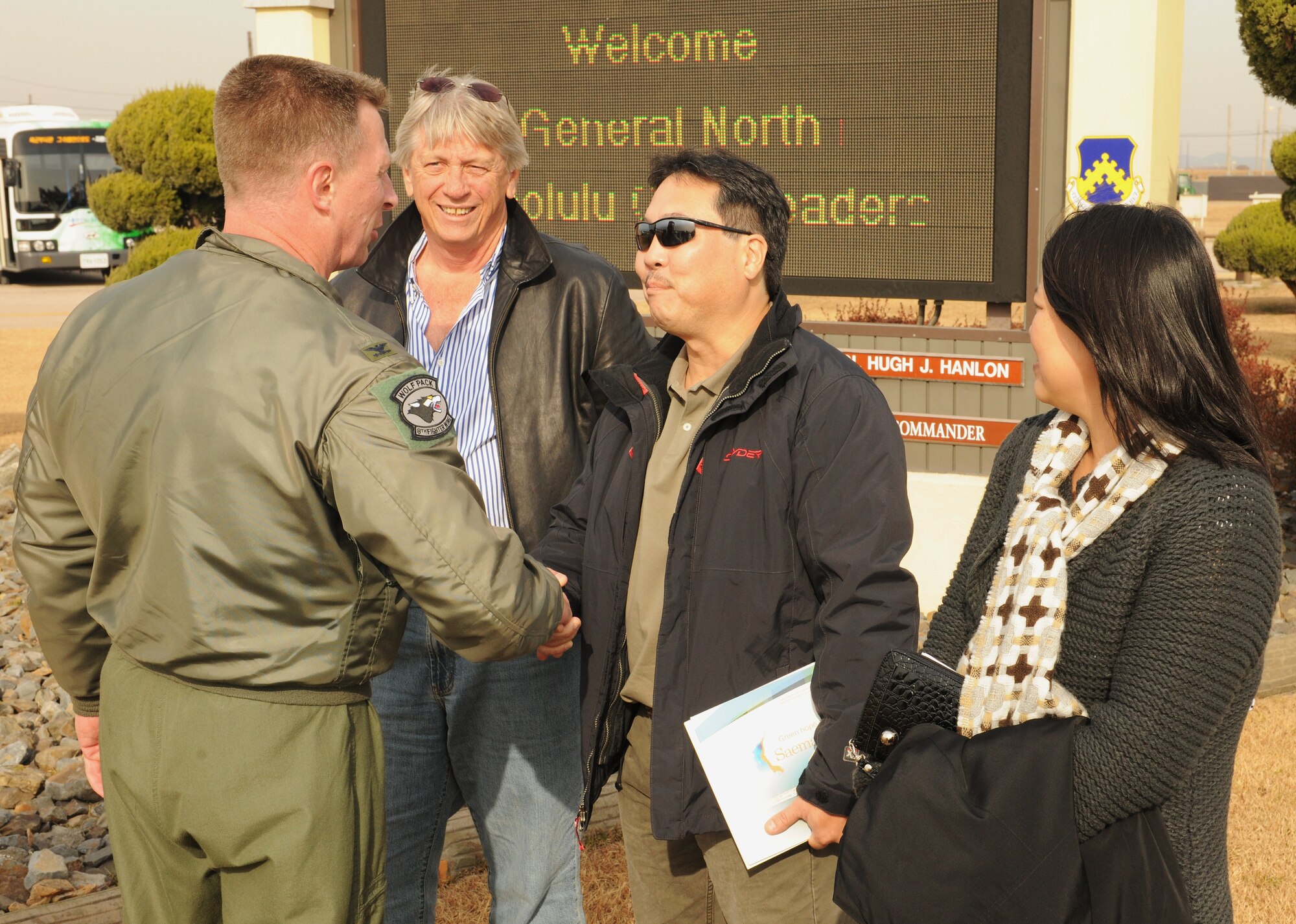 KUNSAN AIR BASE, Republic of Korea -- Col. John Dolan, 8th Fighter Wing commander, greets Kyle Nakamura and Tom Ritchie, guests of the wing as part of a distinguished visitor group that accompanied Gen. Gary North, Pacific Air Forces commander, to various bases within the command during the week. (U.S. Air Force photo/Senior Airman Ciara Wymbs)