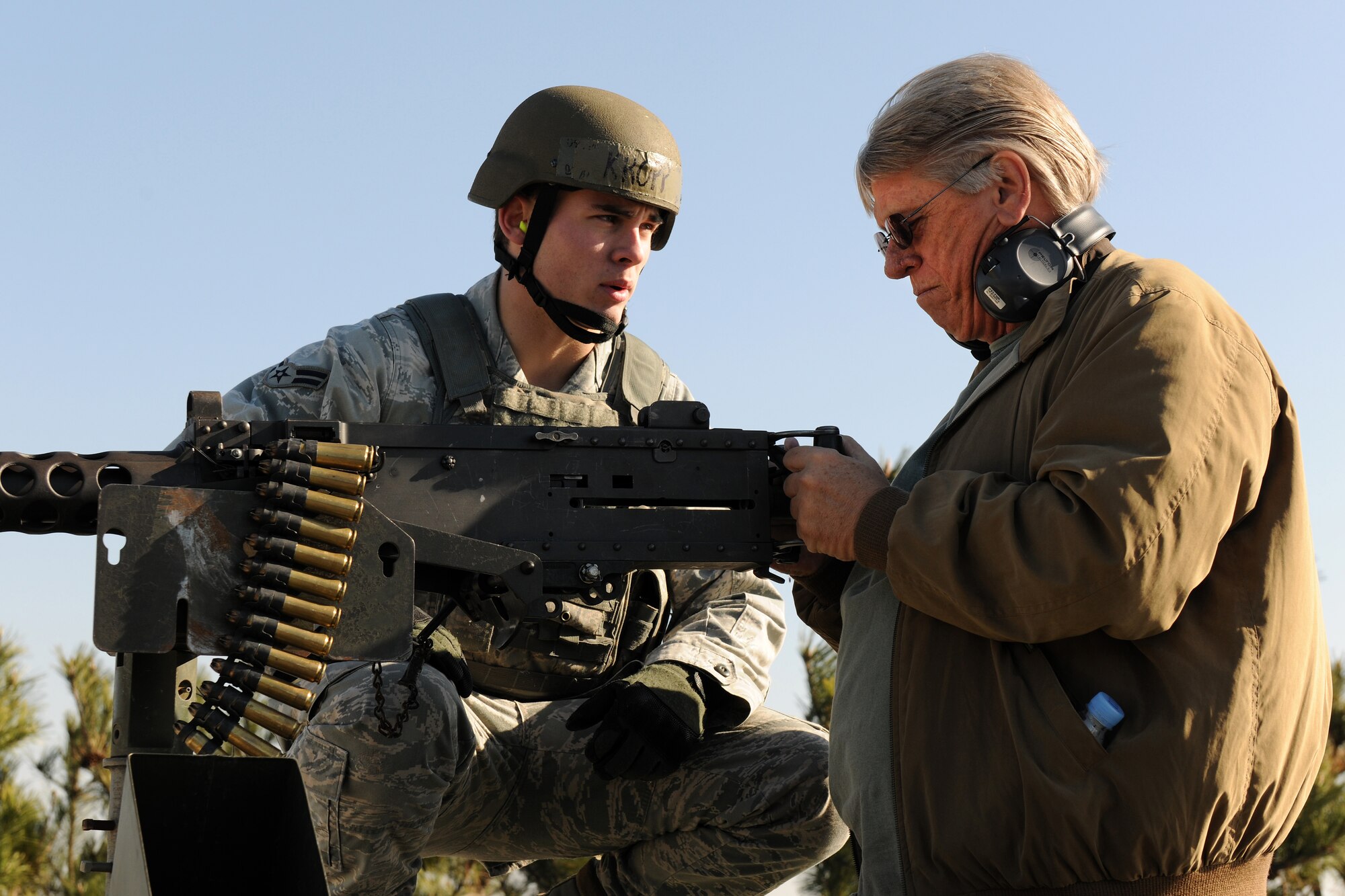 KUNSAN AIR BASE, Republic of Korea -- Airman Blane Kropp, 8th Security Forces Squadron, instructs Tom Ritchie, Co-Incorporator and Vice Chairman of Pacific Rim Bank in Honolulu, Hawaii, on the proper procedures to fire a .50 caliber rifle down range during a visit to the base Nov. 22. Mr. Ritchie was part of a distinguished visitor group that accompanied Gen. Gary North, Pacific Air Forces commander, to various bases within the command during the week. (U.S. Air Force photo/Staff Sgt. Jonathan Pomeroy)