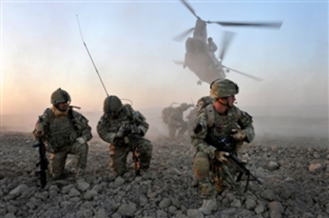 Two CH-47 Chinooks insert soldiers from D Company of The Argyll and Sutherland Highlanders, 5th Battalion, The Royal Regiment of Scotland, and officers from the Afghan National Police into Helmand Province, Nov. 16, 2010. British soldiers and Afghan police mounted an air insertion operation to re-establishing government control in an area of Helmand province previously under heavy Taliban influence.

