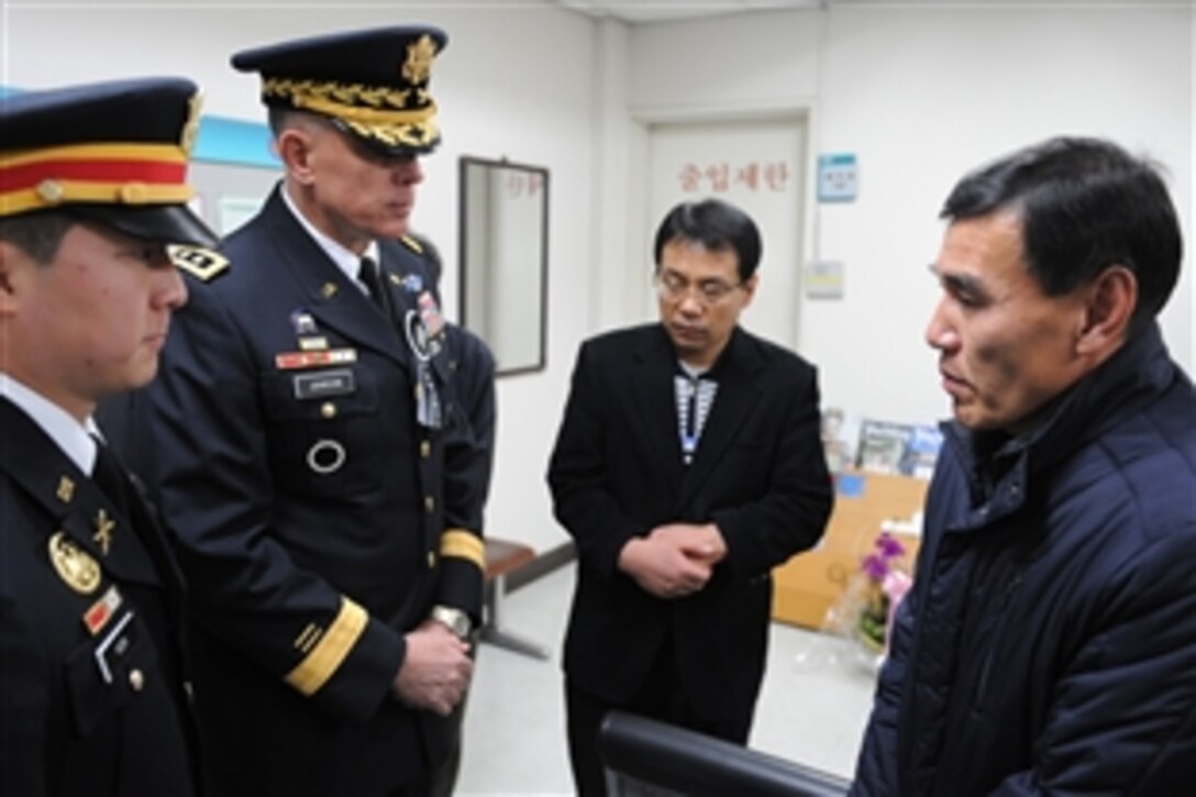 U.S, Army Lt. Gen. John D. Johnson, second from left, offers condolences, on behalf of the U.S. military forces, at the Nov. 27, 2010, funeral services for two South Korean Marines. Sgt. Seo Jeong-wu and Pfc. Moon Gwang-wuk were killed during North Korea's unprovoked attack on Yeonpyeong Island. Johnson is 8th Army commanding general and chief of staff of United Nations Command, Combined Forces Command and U.S. Forces Korea.

