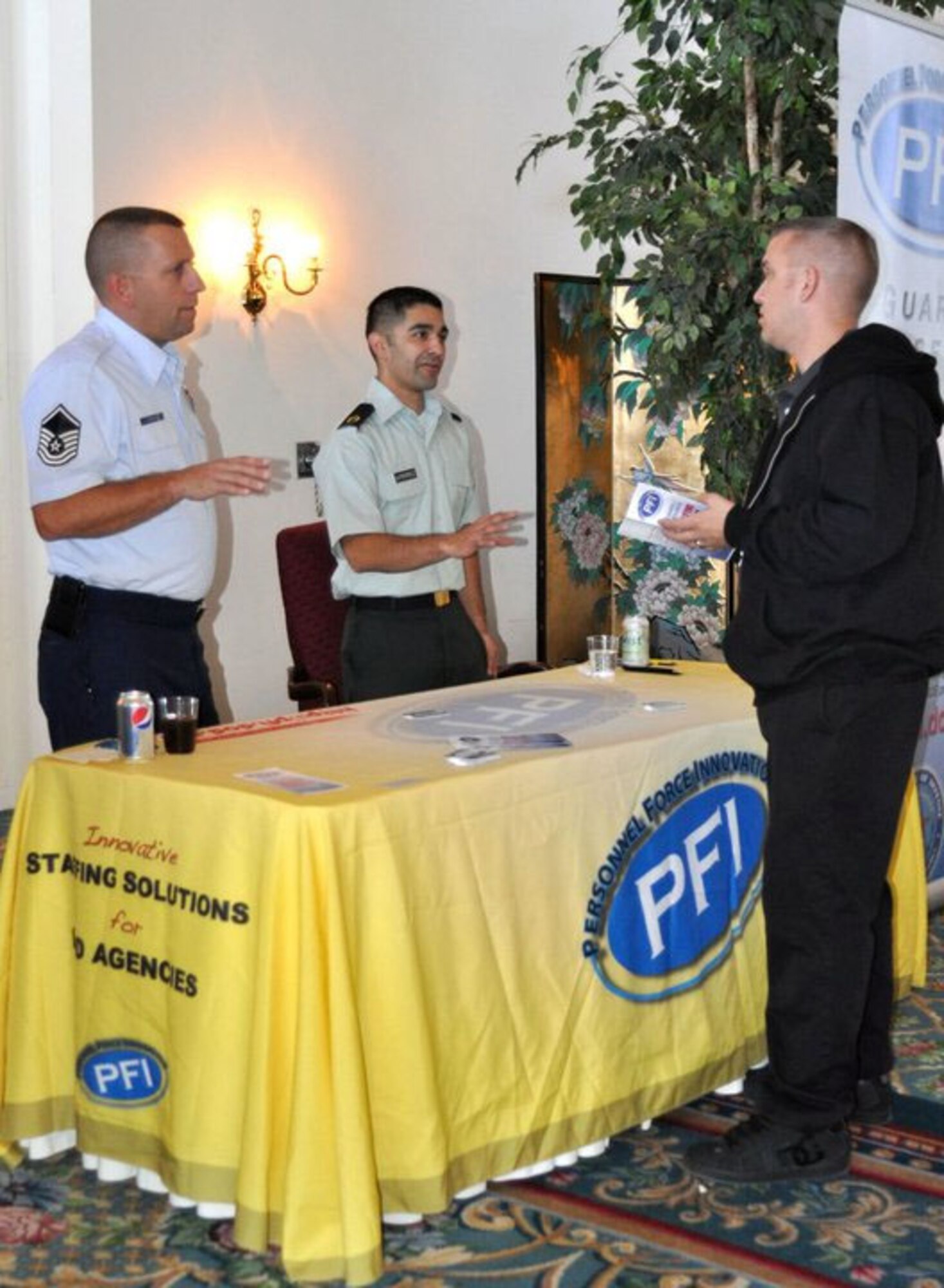 Master Sgt. Kevin Stath and Staff Sgt. Oscar Gutierrez answer questions about Personnel Force Innovation during the Yellow Ribbon ceremony. March Air Reserve Base held a Yellow Ribbon event November 12-14 in San Diego with Airmen attending from March, Beale, McChord and Travis Air Bases.   (U.S. Air Force photo by Valerie M Palacios)
