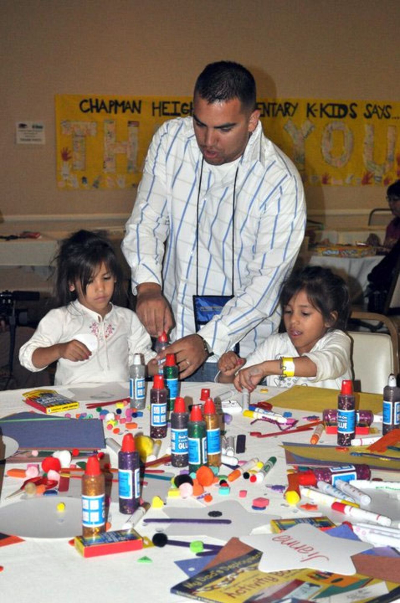 SSgt. Adam Villalobos lends his daughters a hand during a social held the first night of the Yellow Ribbon. March Air Reserve Base held a Yellow Ribbon event November 12-14 in San Diego with Airmen attending from March, Beale, McChord and Travis Air Bases.    (U.S. Air Force photo by Valerie M Palacios)