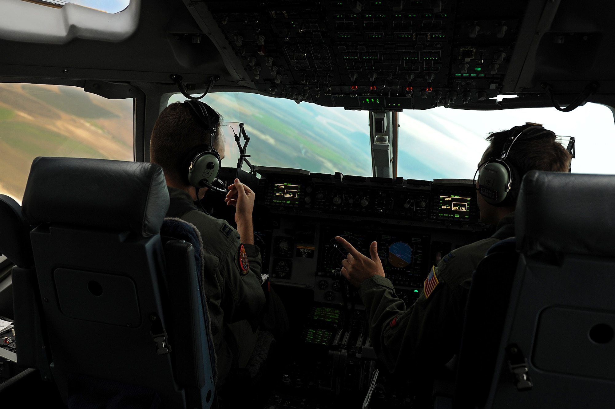 Capts. Rob Greeson and Nate Padgett, 535th Airlift Squadron pilots, fly a C-17 toward a drop zone during an airdrop training mission Nov. 18. The 535th AS aircrew trained in unrestricted descent assault landings, air drop, combat offloads, air refueling, night vision goggle training, combat offloads, low levels, mountainous terrain, assault landings, threat responses and multiple ship formation training during a five day training trip to Washington Nov 12-17 and participated in the Mobility Air Forces Exercise at Nellis Air Force Base, Nev., Nov. 18. (U.S. Air Force photo/Staff Sgt. Mike Meares)