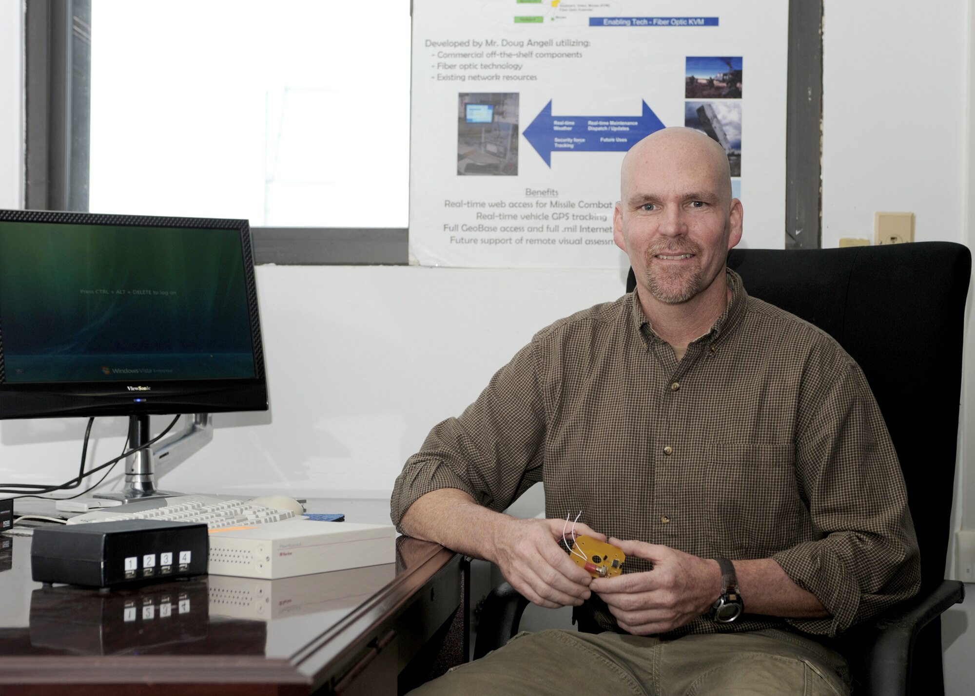 Douglas Angell poses with his invention, the Launch Control Center NetLink, Nov. 23, 2010, at Minot Air Force Base, N.D. The LCC NetLink concept allows personal computing capability to crewmembers while they are on duty at the missile alert facilities. Mr. Angell is a 526th Intercontinental Ballistic Missile Systems Group technical engineer. (U.S. Air Force Photo/Airman 1st Class Aaron-Forrest Wainwright)