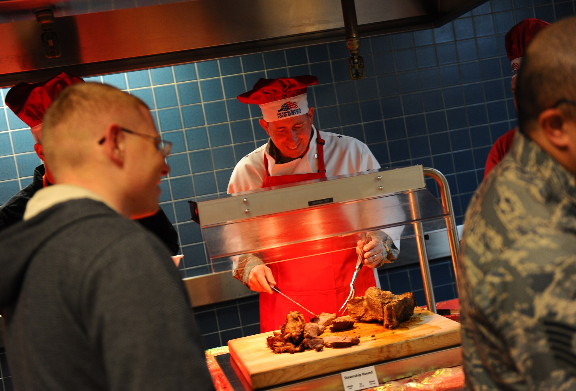 OFFUTT AIR FORCE BASE, Neb. - Brig. Gen. John N.T. Shanahan, 55th Wing commander, carves up some Thanksgiving roast for members of Team Offutt at the Ronald L. King Dining facility for an annual Thanksgiving dinner Nov. 25.  Airmen, retirees and their families got a chance to have their Thanksgiving dinner professionally prepared by the Air Combat Command John L. Hennessy award winning Airmen while members of wing leadership served the food. U.S. Air Force photo by Josh Plueger (Released)
