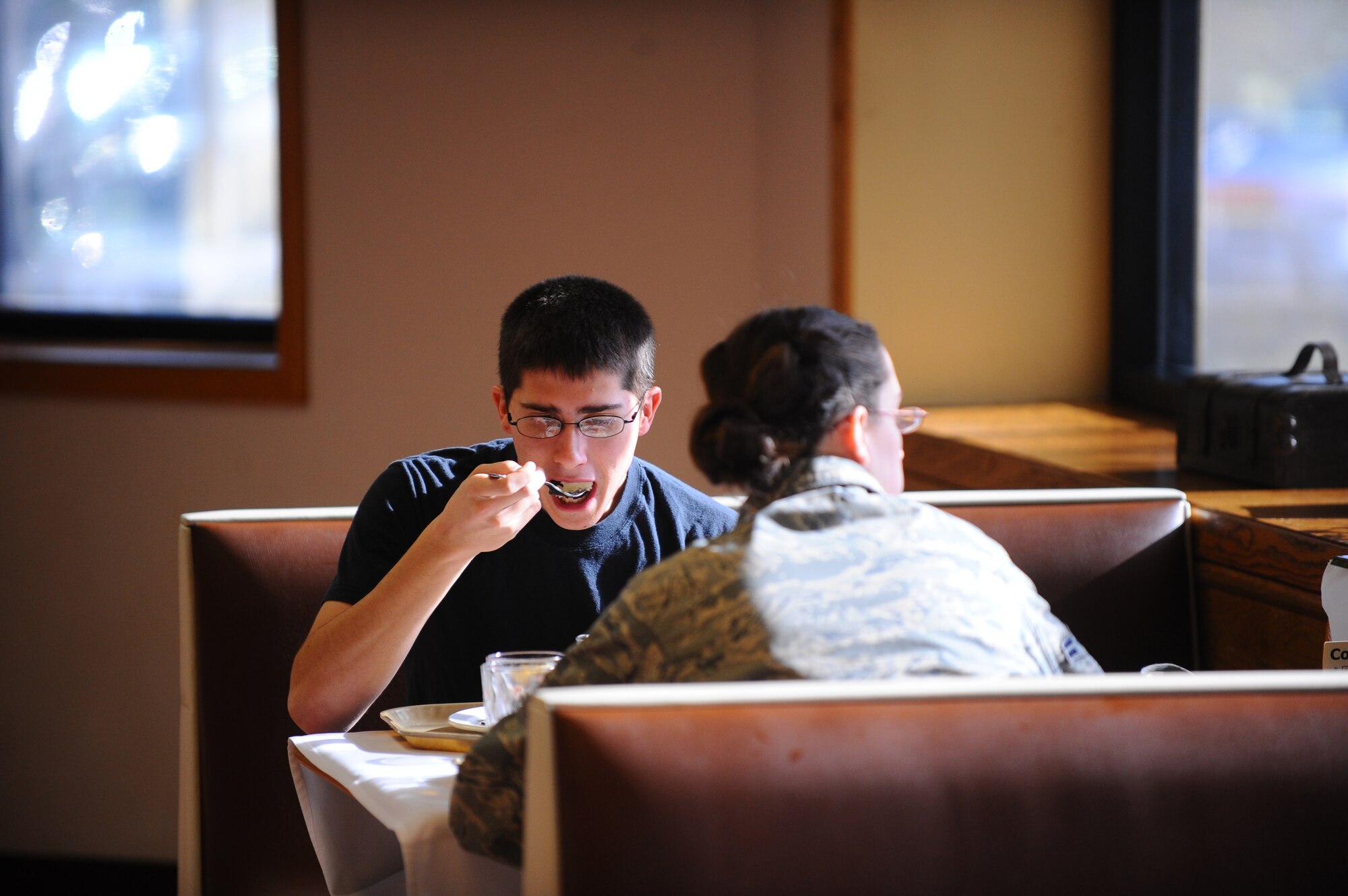 OFFUTT AIR FORCE BASE, Neb.- Senior Airman Ben Mele, a communication navigator with the 55th Aircraft Maintenance Squadron, enjoys his Thanksgiving dinner at the Ronald L. King Dining facility during the annual dinner Nov. 25.  Airmen, retirees and their families got a chance to have their Thanksgiving dinner professionally prepared by the Air Combat Command John L. Hennessy award winning Airmen while wing leadership served the food. U.S. Air Force photo by Josh Plueger (Released)
