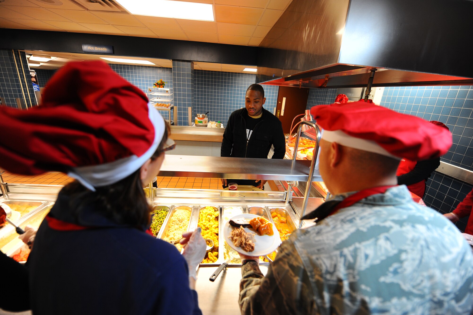 OFFUTT AIR FORCE BASE, Neb.- Airman 1st Class Tramell Lowdermilk, a bio-environmental engineer with the 55th Aerospace Medical Squadron, chooses from a large selection of side dishes at the Ronald L. King Dining facility at an annual  Thanksgiving dinner Nov. 25.  Airmen, retirees and their families got a chance to have their Thanksgiving dinner professionally prepared by the Air Combat Command John L. Hennessy award winning Airmen while wing leadership served the food. U.S. Air Force photo by Josh Plueger (Released)
