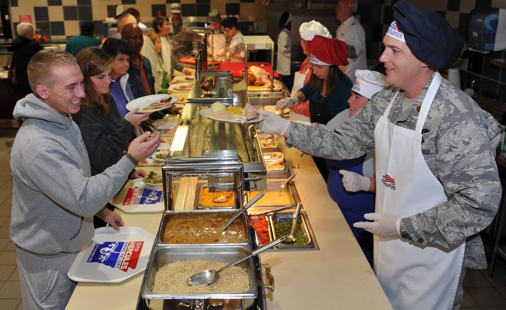 Maj. Justin Barry, 314th Airlift Maintenance Squadron commander, serves a stacked plate to Airman 1st Class Andrew Erwin, 314th Airlift Maintenance Squadron crew chief, Nov. 25, 2010, at the Hercules Dining Facility at Little Rock Air Force Base, Ark. Several base leaders and their families worked the Thanksgiving meal as servers during the holiday event. (U.S. Air Force photo by Staff Sgt. Chris Willis)