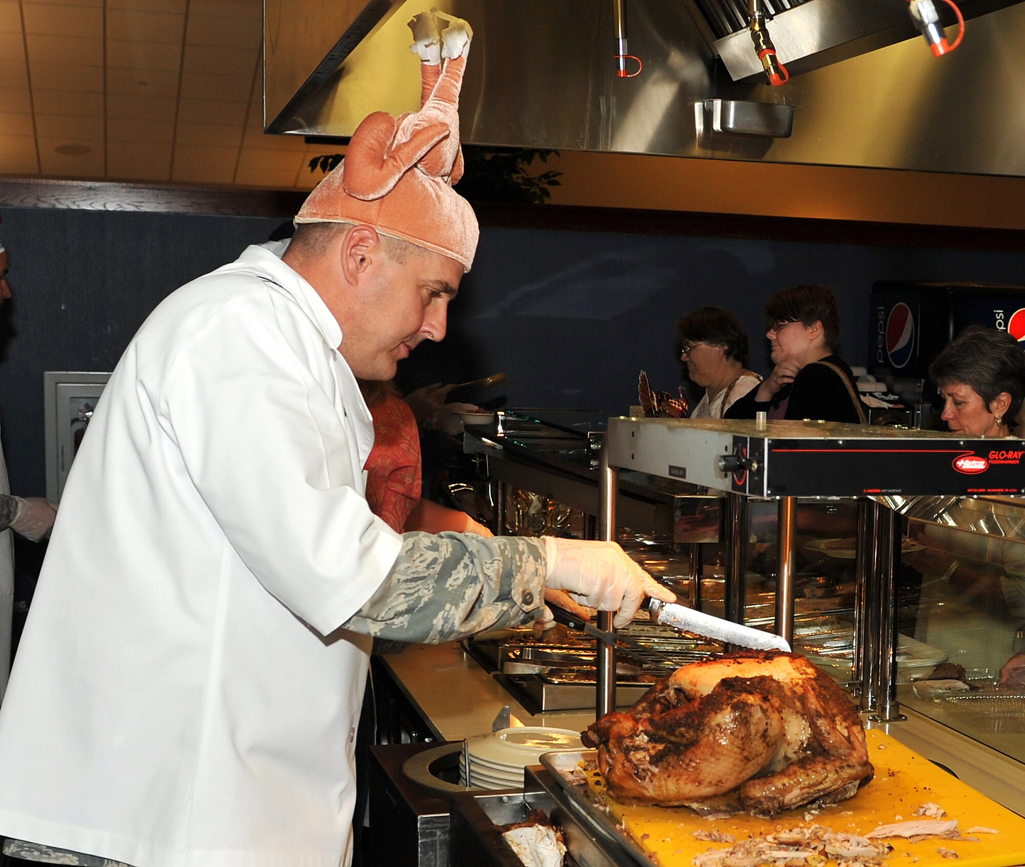 Col. Mike Minihan, 19th Airlift Wing commander, cuts one of the many turkeys served Nov. 25, 2010, at the Hercules Dining Facility at Little Rock Air Force Base, Ark. The dining facility opened its doors to all active duty and retired military members and their family for a special Thanksgiving Day meal.  (U.S. Air Force photo by Staff Sgt. Chris Willis)