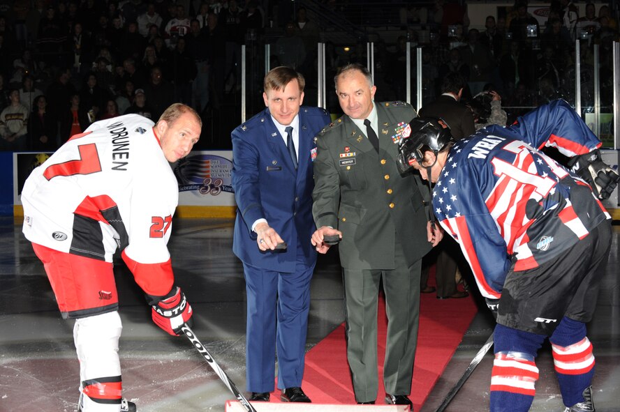 RAPID CITY, S.D.-- Col. Jeffrey Taliaferro, 28th Bomb Wing commander (left) and Col. James Webster, South Dakota Army National Guard chief of staff, drop the ceremonial puck during Military Appreciation Night with the Rapid City Rush at the Rapid City Civic Center, Oct. 26. The Odessa Jackalopes beat the Rush with a score of 8-0. (U.S. Air Force photo/Master Sgt. Loren J. Bonser)