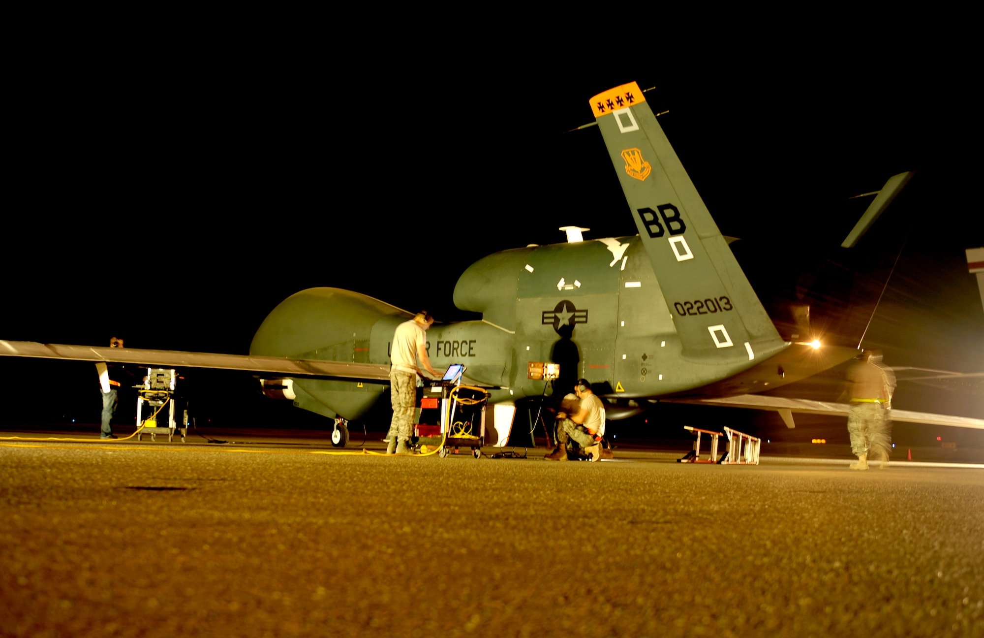 Maintenance technicians go over pre-flight inspections on their RQ-4 Global Hawk aircraft before a mission while deployed Nov. 23, 2010, at an air base in Southwest Asia. The Airmen are assigned to the 380th Expeditionary Aircraft Maintenance Squadron. (U.S. Air Force photo/Staff Sgt. Andy M. Kin)