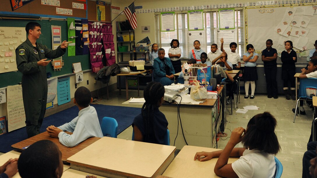 Captain Paul Bozzo, 1st Helicopter Squadron special missions pilot, shares his experience as a pilot with 4th grade students at Barnaby Manor Elementary School, Oxon Hill, Md, Nov. 18. The visit was part of the schools Community Day program, stressing the importance of doing well in school. Capt Bozzo spoke to more than 300 students ranging from pre-kindergarten through 5th grade and received hand-made ?thank you? cards for his visit. (U.S. Air Force Photo by 2nd Lt. Mark Flannery)
