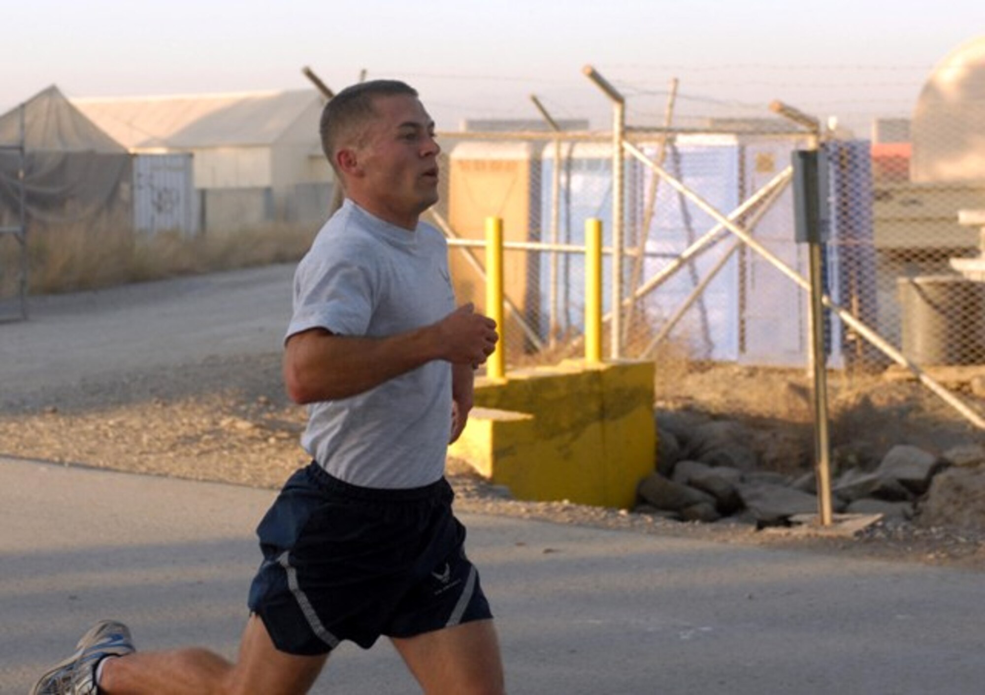 KHOWST PROVINCE, Afghanistan - 1st Lt. Joseph Czarbaranek, Air Force Research Lab, currently deployed to Task Force Silver Fox, unmanned aerial vehicle officer in charge, crosses the finish line first with a time of 17:51 at the Thanksgiving Day 5K Run at Forward Operating Base Salerno Nov. 25. (U.S. Army Photo/ Pfc. Chris McKenna)
