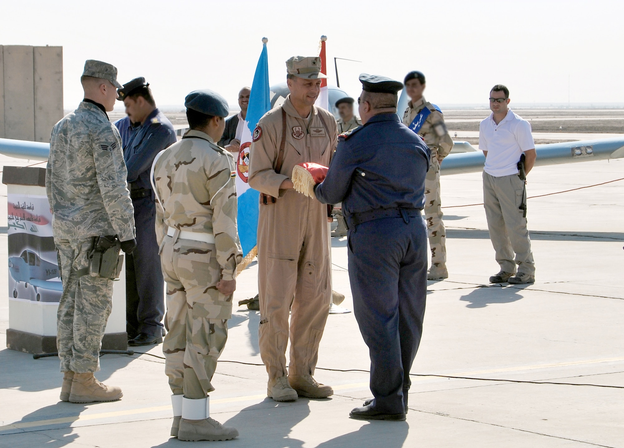 Brig. Gen. Scott Hanson exchanges gifts Nov. 23, 2010, at Ali Air Base, Iraq, during a ceremony celebrating the arrival of the Iraqi Air Force's Squadron 70 and the grand opening of a new dining facility. General Hanson is the 321st Air Expeditionary Wing commander and Iraqi Training and Advisory Mission - Air Force director. (U.S. Air Force photo/Staff Sgt. Eric Donner)