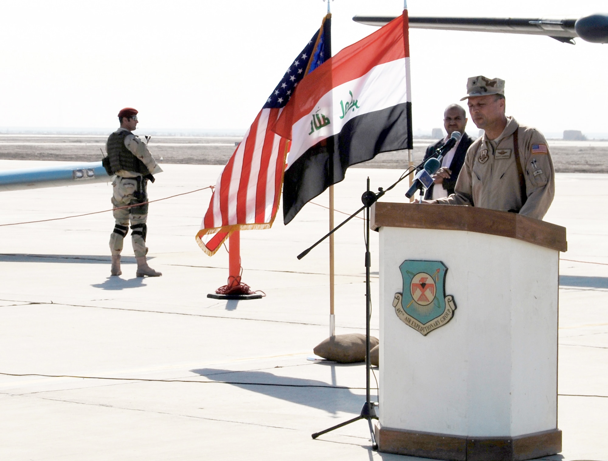 Brig. Gen. Scott Hanson addresses audience members gathered at Ali Air Base, Iraq, Nov. 23, 2010, during a ceremony celebrating the arrival of the Iraqi Air Force's Squadron 70 and the grand opening of a new dining facility. General Hanson is the 321st Air Expeditionary Wing commander and Iraqi Training and Advisory Mission - Air Force director. (U.S. Air Force photo/Staff Sgt. Eric Donner)