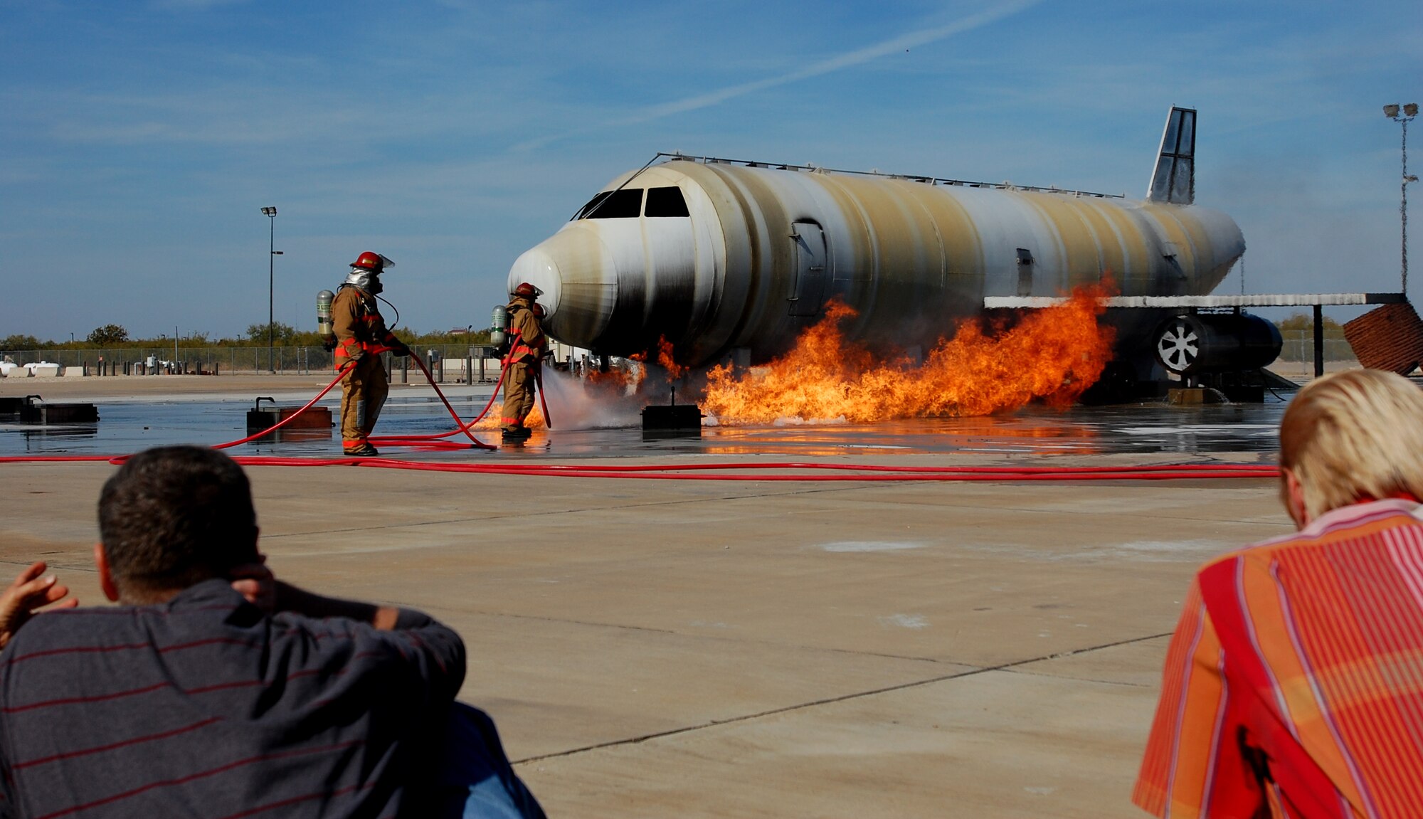 GOODFELLOW AIR FORCE BASE, Texas - Airmen from the 312th Training Squadron extinguish a fire on a training module to demonstrate an aircraft incident during the Community Appreciation Day and Santa's Workshop Nov. 20.  The events were open to the local community and offered a glimpse of the wing's mission and operations.  (U.S. Air Force photo/Staff Sgt. Heather Rodgers)

