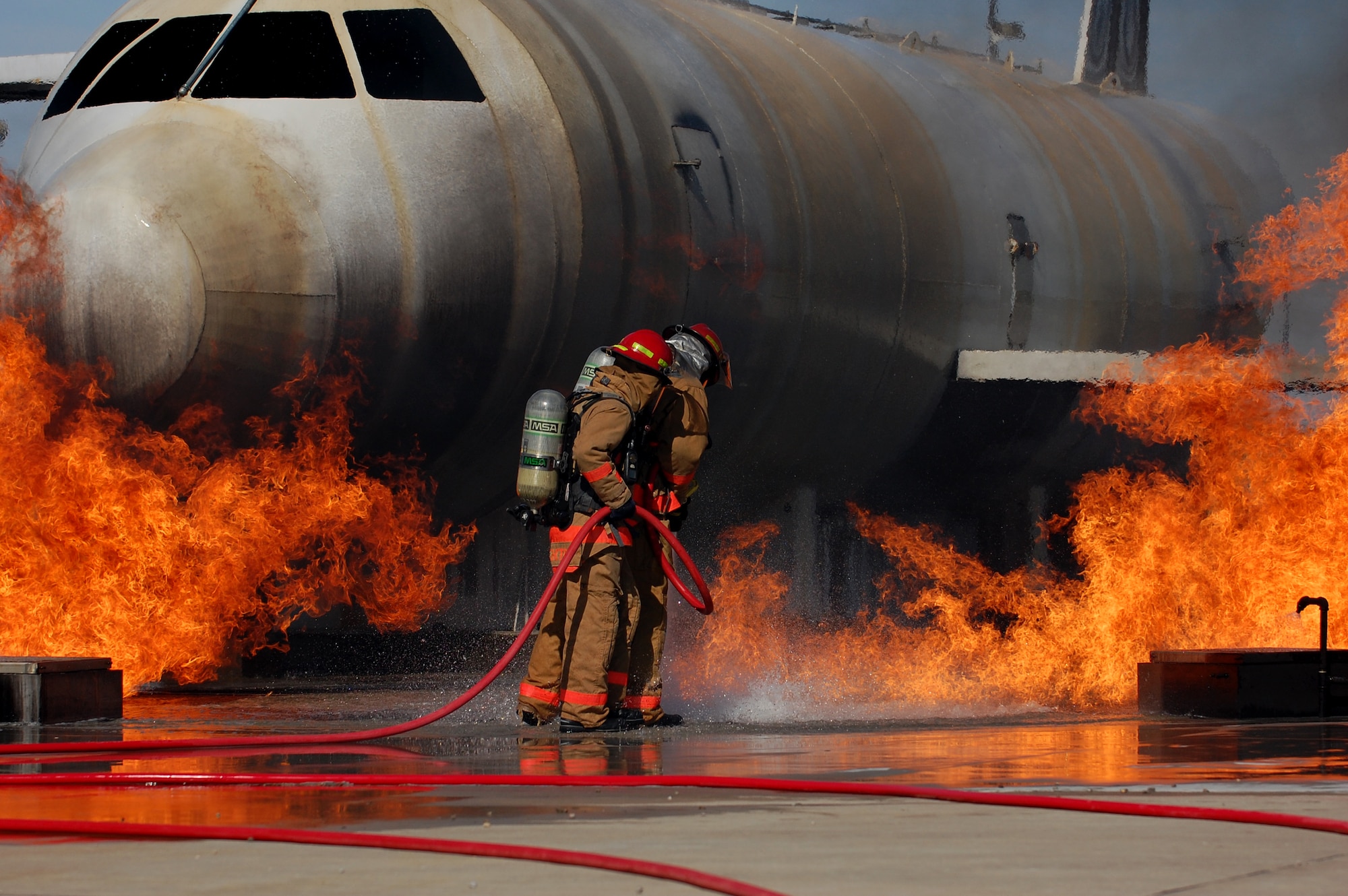 GOODFELLOW AIR FORCE BASE, Texas - Airmen from the 312th Training Squadron extinguish a fire on a training module to demonstrate an aircraft incident at during the Community Appreciation Day and Santa's Workshop Nov. 20.  The event was open to the local community and offered a glimpse of the wing's mission and operations.  (U.S. Air Force photo/Staff Sgt. Heather Rodgers)


