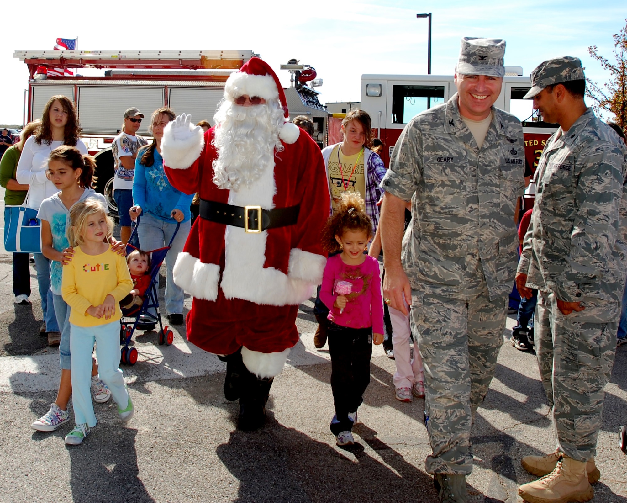 GOODFELLOW AIR FORCE BASE, Texas - Santa Claus, escorted by Col. Thomas Geary, 17th Training Wing Commander,  joins the holiday festivities at Goodfellow's Community Appreciation Day and Santa's Workshop Nov. 20.  The base opened its gates to the local community for the day, offering a glimpse of the wing's mission and operations.  (U.S. Air Force photo/Staff Sgt. Heather Rodgers)